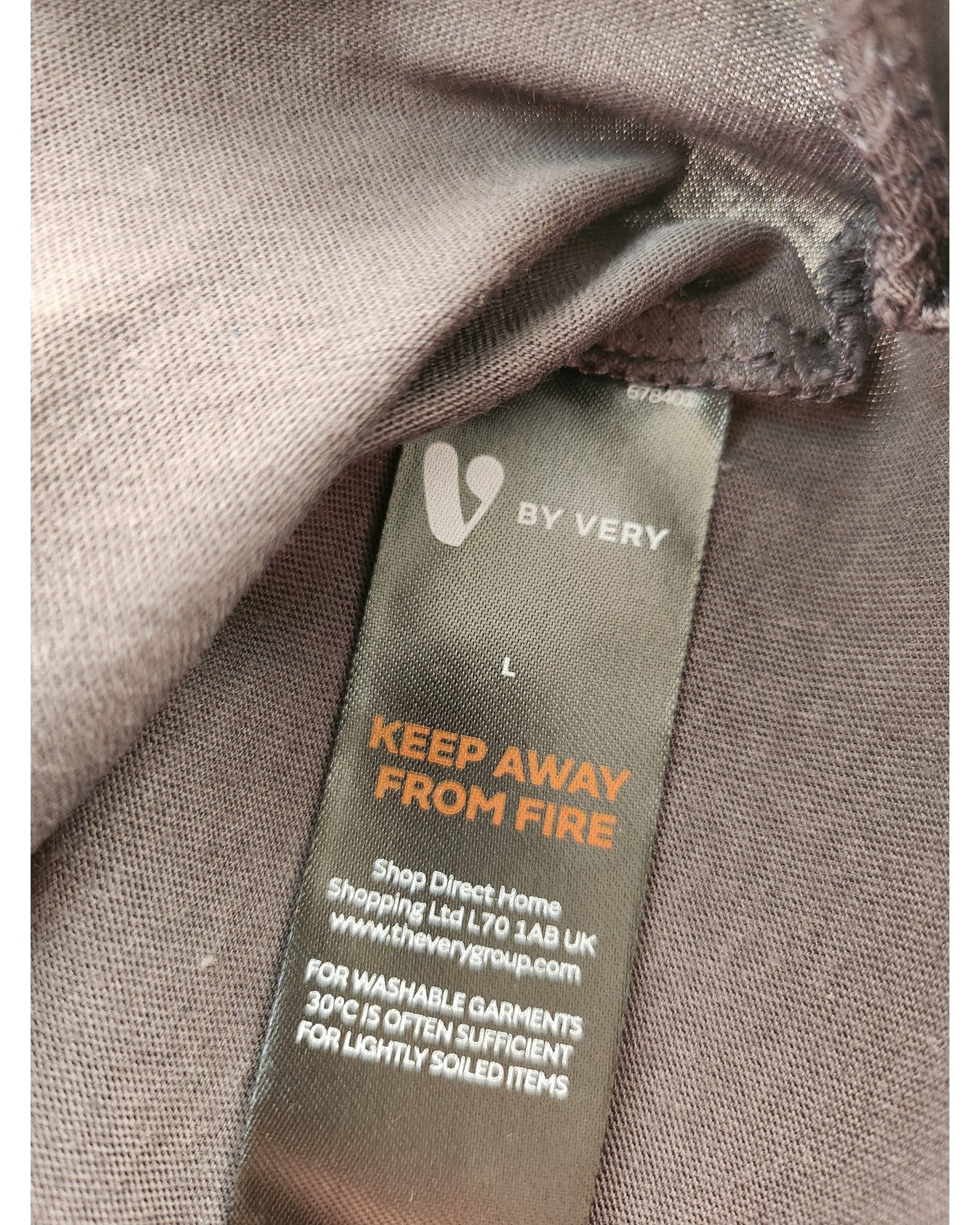 The touched out mama upcycled breastfeeding & pumping AC DC t-shirt L features a label with BY VERY and KEEP AWAY FROM FIRE, produced by Shop Direct Home Shopping Ltd in the UK. Wash lightly soiled items at 30°C. Its part of our eco-friendly line, highlighting sustainable practices.