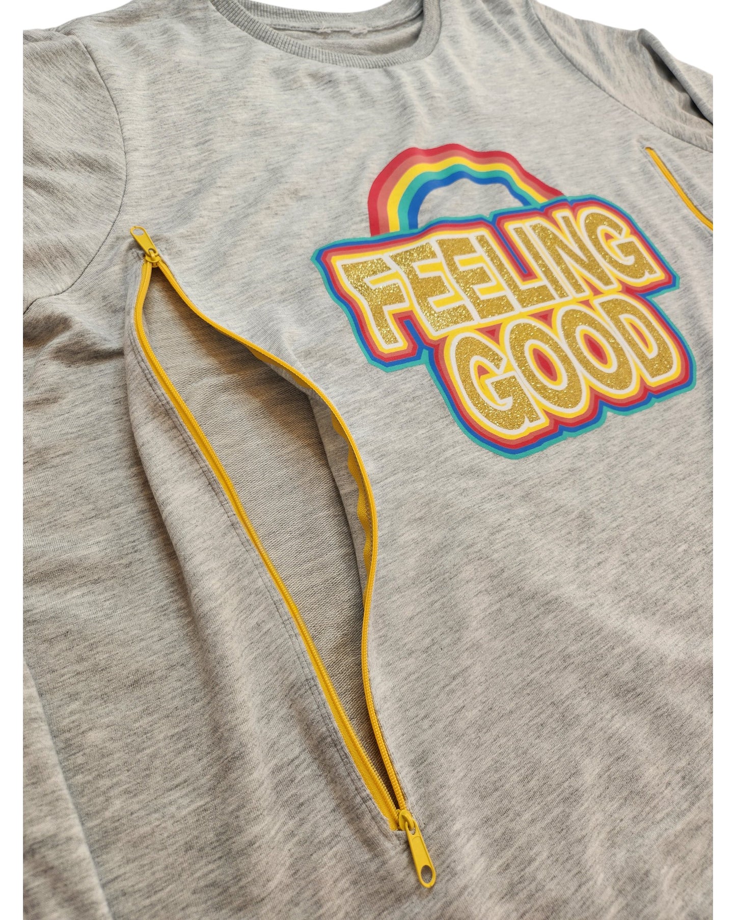 Touched out mama offers the Upcycled Breastfeeding (Nursing) & Pumping Feeling Good Sweatshirt UK22, a gray sweatshirt with colorful FEELING GOOD text and rainbow design. It features two diagonal yellow zippers for style, perfect for eco-conscious fashion lovers.