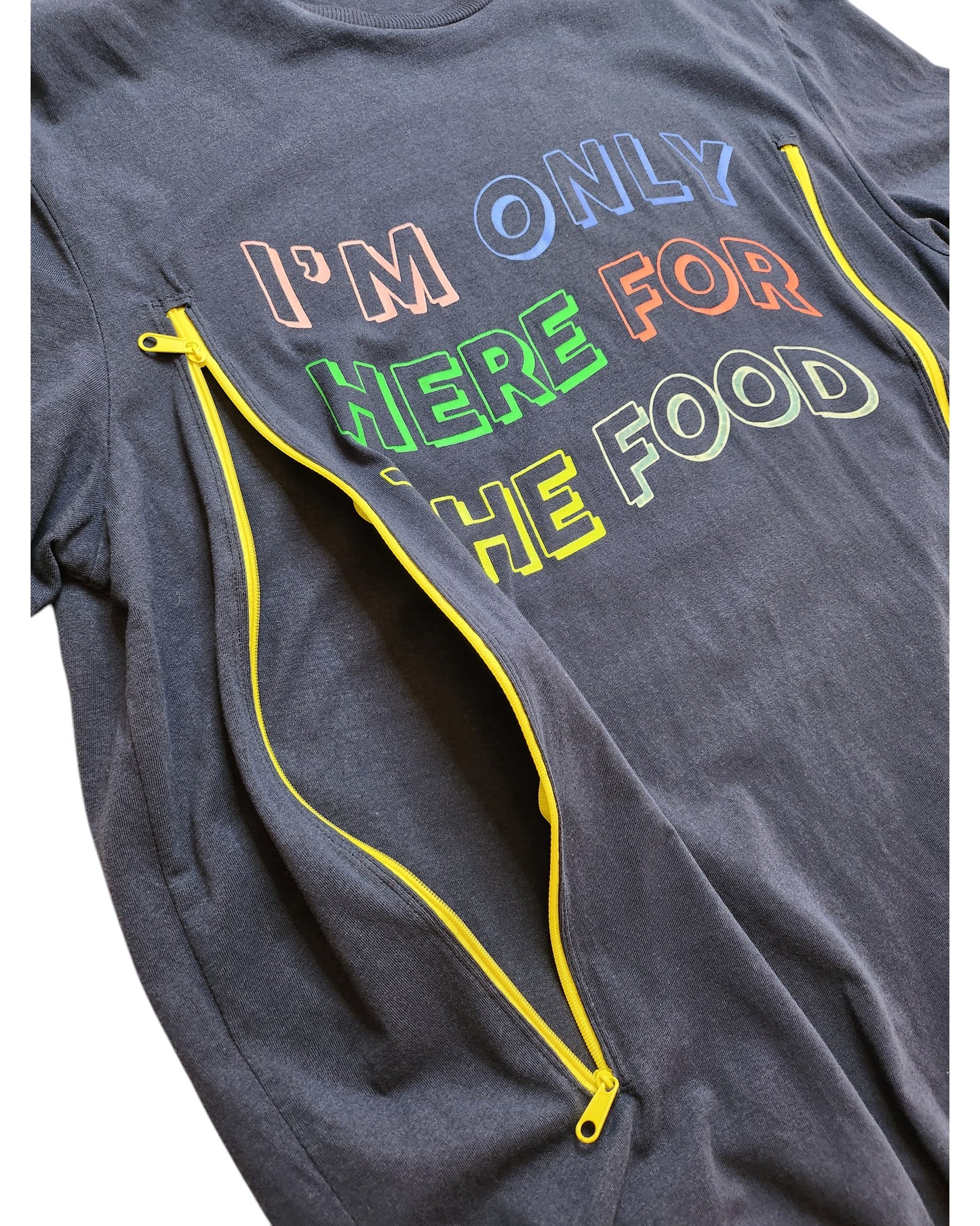 The Upcycled Breastfeeding & Pumping Food t-shirt by touched out mama is a dark gray tee featuring colorful Im only here for the food text. It boasts two yellow zippers running diagonally alongside the words, adding a unique flair to this sustainable piece.