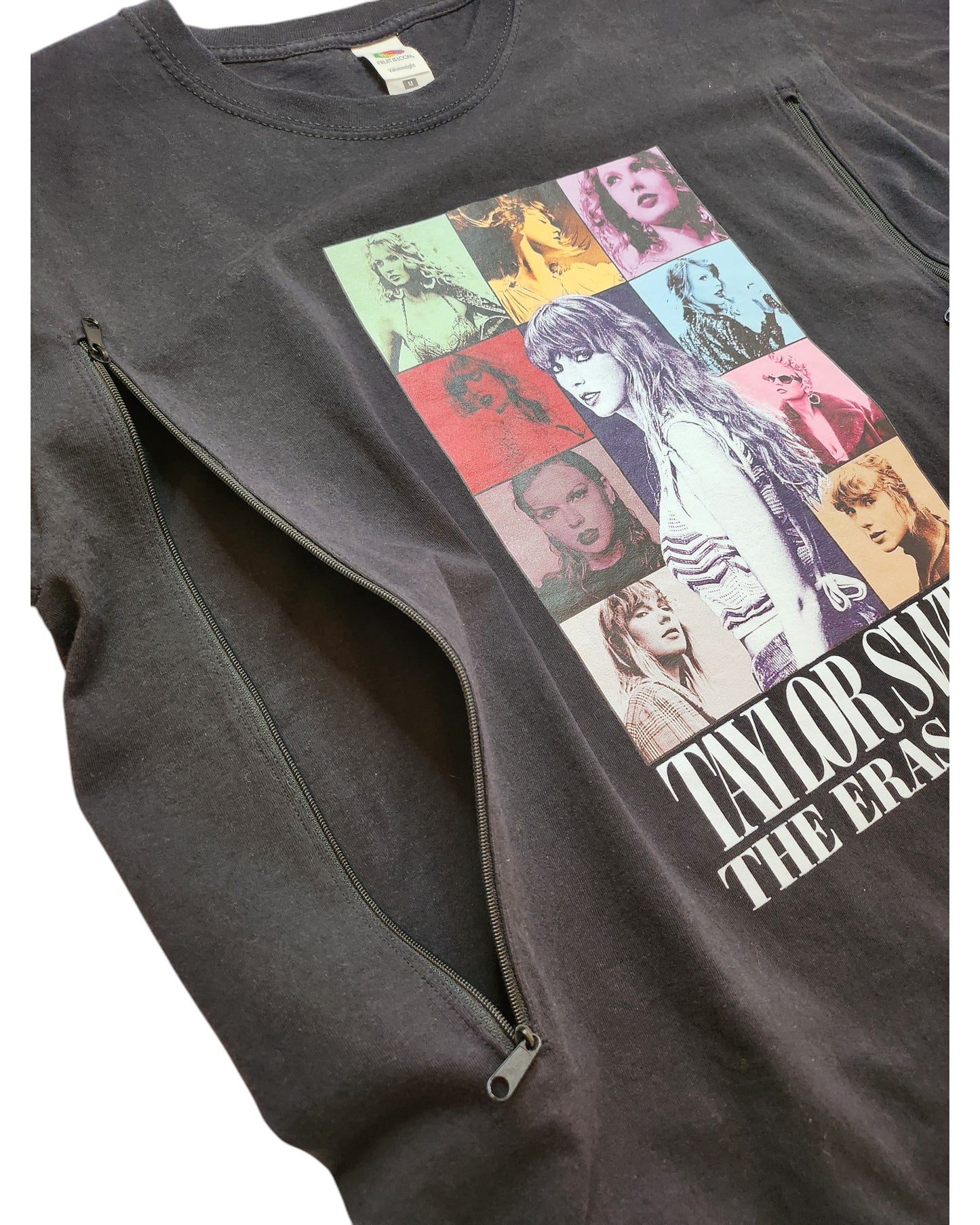 An upcycled black Taylor Swift Tour sweatshirt by touched out mama showcases a grid of colorful images from various music eras. This preloved piece, repurposed for breastfeeding and pumping, features side zippers for style and sustainability.