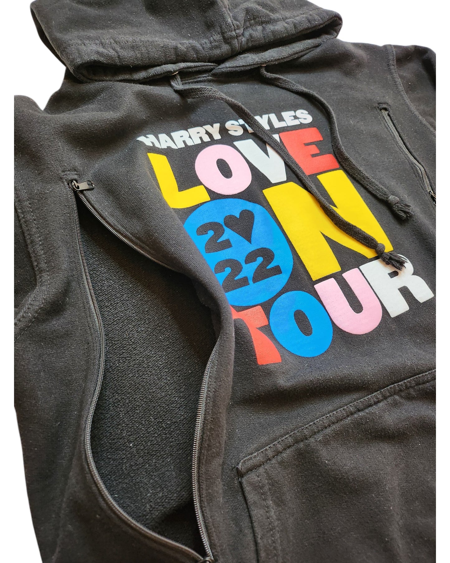 The Upcycled Breastfeeding (Nursing) & Pumping Harry Styles Hoodie M by touched out mama is a black hoodie with a vibrant Love On Tour 2022 design, heart symbol, and partially unzipped style. Its made from eco-friendly upcycled materials for a sustainable fashion statement.