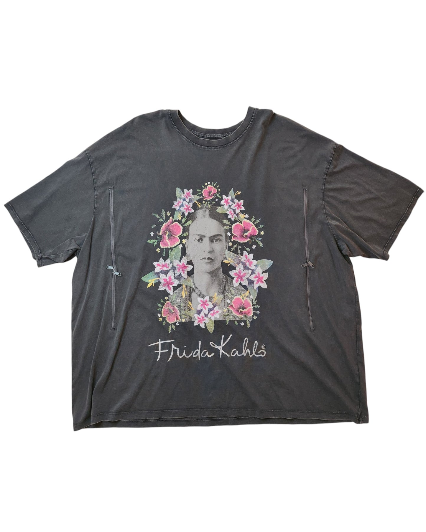 The touched out mama Upcycled Breastfeeding & Pumping Frida Kahlo T-shirt in dark gray showcases an illustrated portrait with pink flowers and greenery, features cursive Frida Kahlo, is eco-friendly with a slightly oversized fit and short sleeves, inspired by upcycled clothing (UK26).