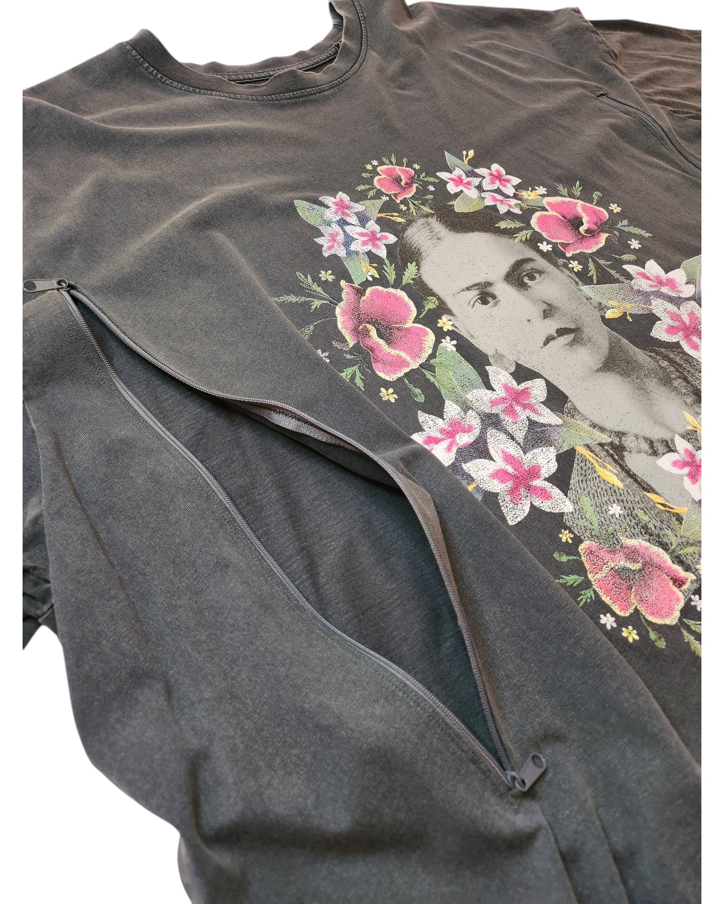 The Upcycled Breastfeeding & Pumping Frida Kahlo T-shirt UK26 by touched out mama is a dark gray shirt made from eco-friendly materials, featuring a woman with a floral crown surrounded by pink and white flowers, and includes a front zipper for convenience.