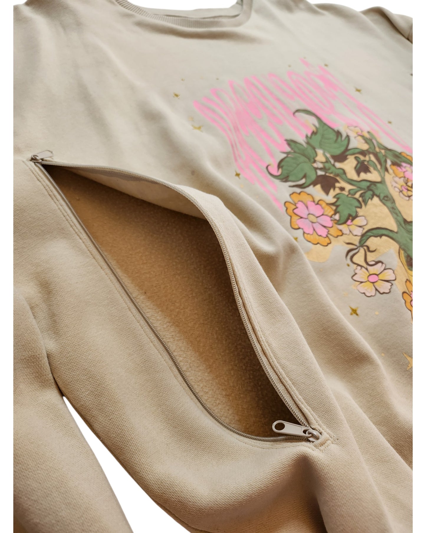 The Upcycled Breastfeeding & Pumping Harry Potter Sweatshirt 2XL by touched out mama boasts a unique, eco-friendly design with beige fabric and a pink-green floral chest print. It offers a side zipper that reveals a soft fleece lining—perfect for discreet breastfeeding or showcasing its cozy texture.