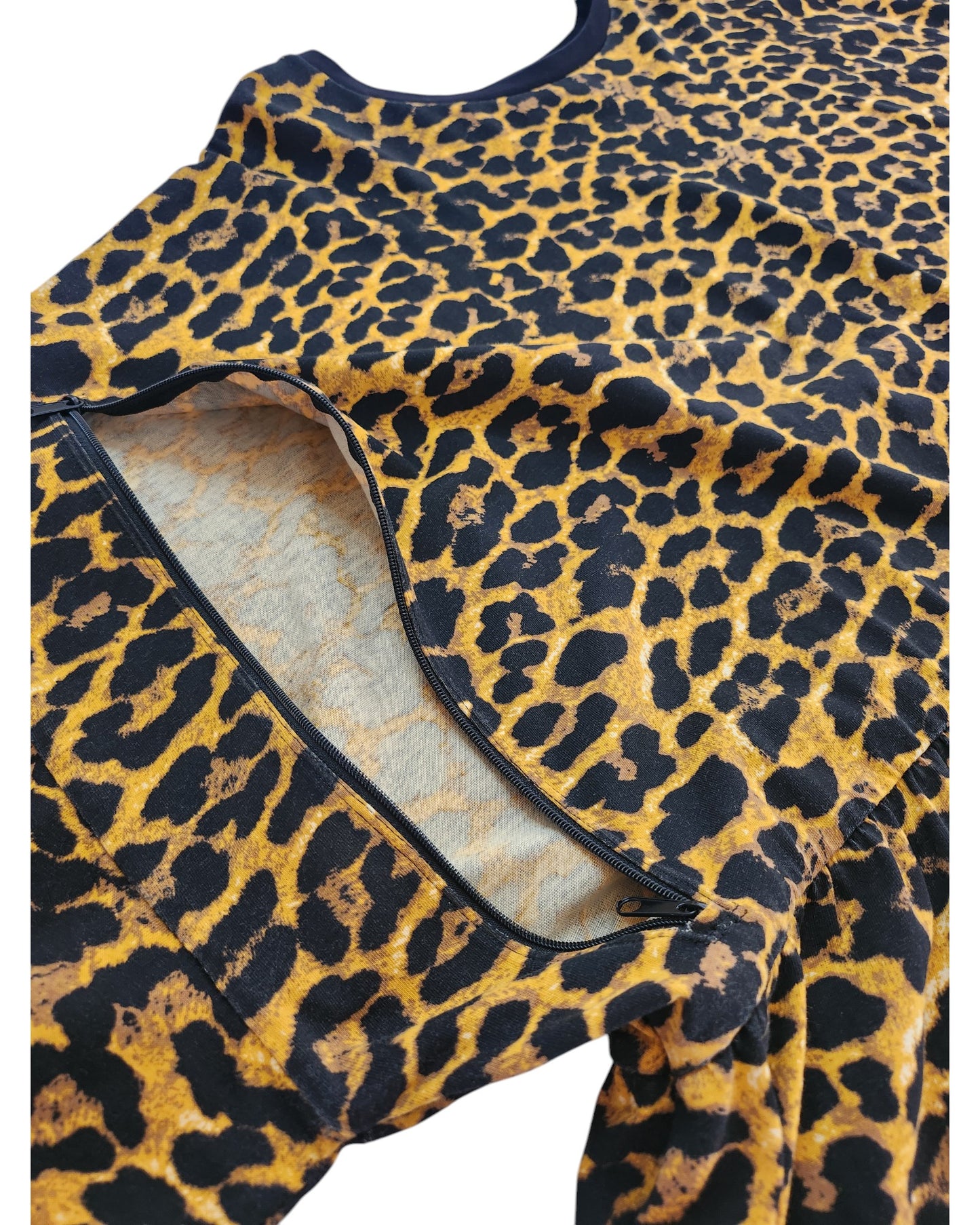 The preloved Upcycled Breastfeeding & Pumping Cheetah T-shirt by touched out mama in UK30 features an unzipped section revealing its inner lining. Dark, irregular spots contrast with a vibrant yellow-orange background, adding unique charm to this distinctive piece.