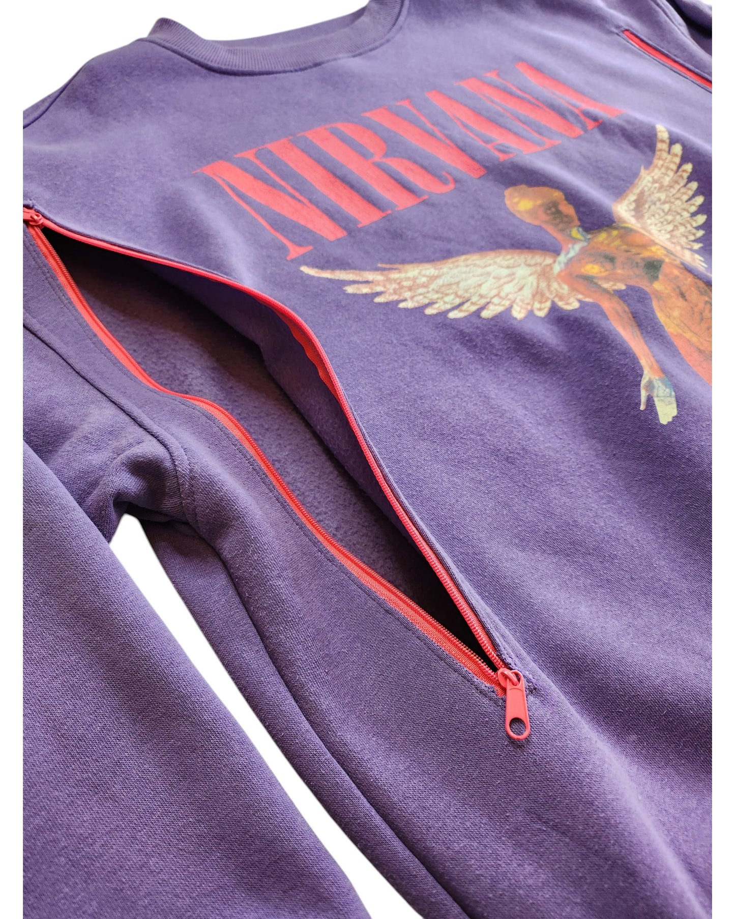 The Upcycled Breastfeeding & Pumping Nirvana Sweatshirt L by touched out mama features a purple design with an angel graphic and NIRVANA above it. Red zippers from shoulders to underarms highlight its unique eco-friendly design, with a low-angle image for dramatic effect.