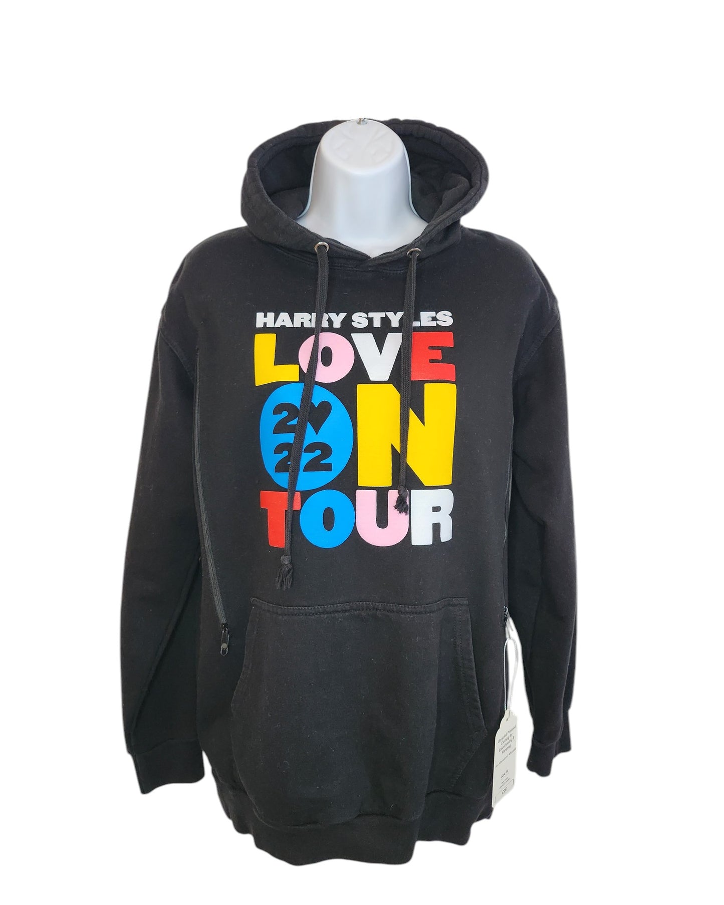 The Upcycled Breastfeeding & Pumping Harry Styles Hoodie M by touched out mama showcases vibrant Harry Styles Love On Tour 2022 text in bold colors and features a convenient neck drawstring with an attached white tag.