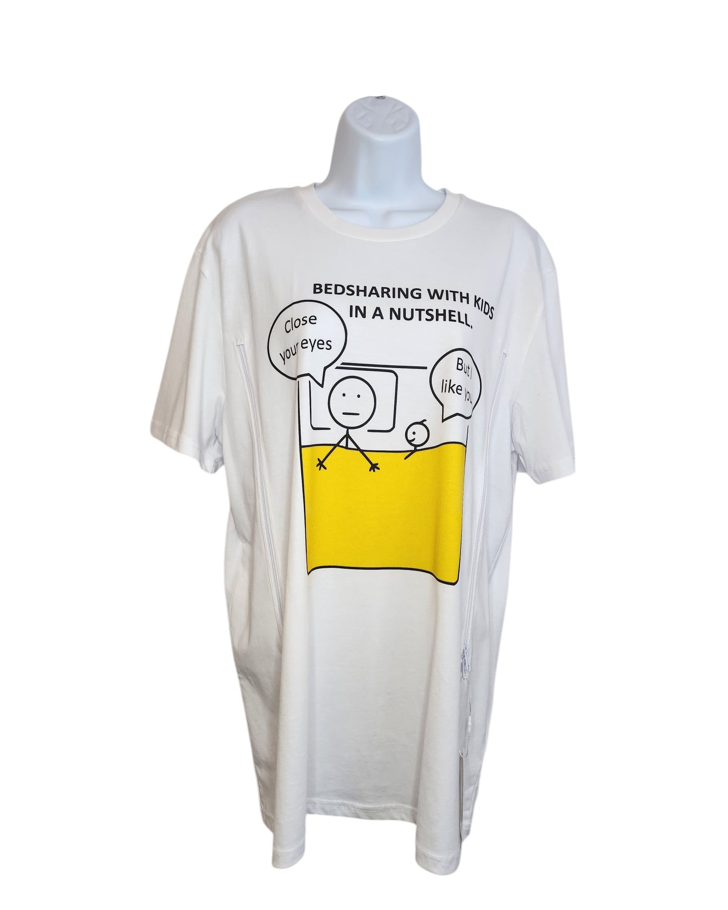 Displayed on a mannequin, the white Upcycled Breastfeeding & Pumping Funny Bedsharing t-shirt by touched out mama features an organic cotton stick figure design of bedsharing with kids. Speech bubbles say, Close your eyes and But I like it here. Available in S, M, L & XL.