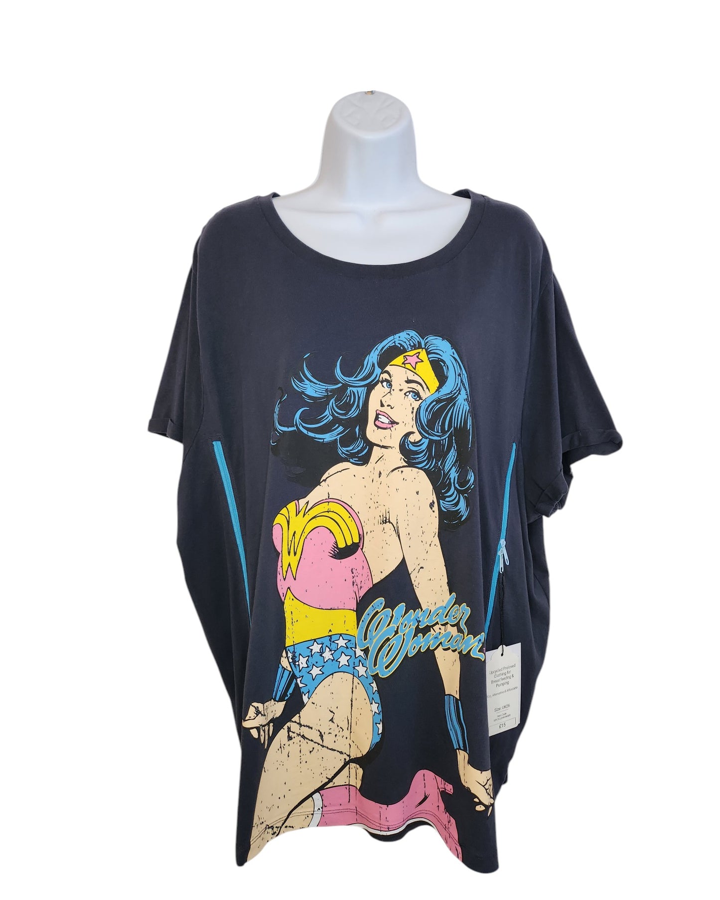The Upcycled Breastfeeding & Pumping Wonder Women t-shirt UK26 by touched out mama, displayed on a mannequin, showcases a superheroine with blue hair and a starry headband in red, blue, and yellow. This dark gray tee blends eco-friendly fashion with vintage charm on its weathered fabric.