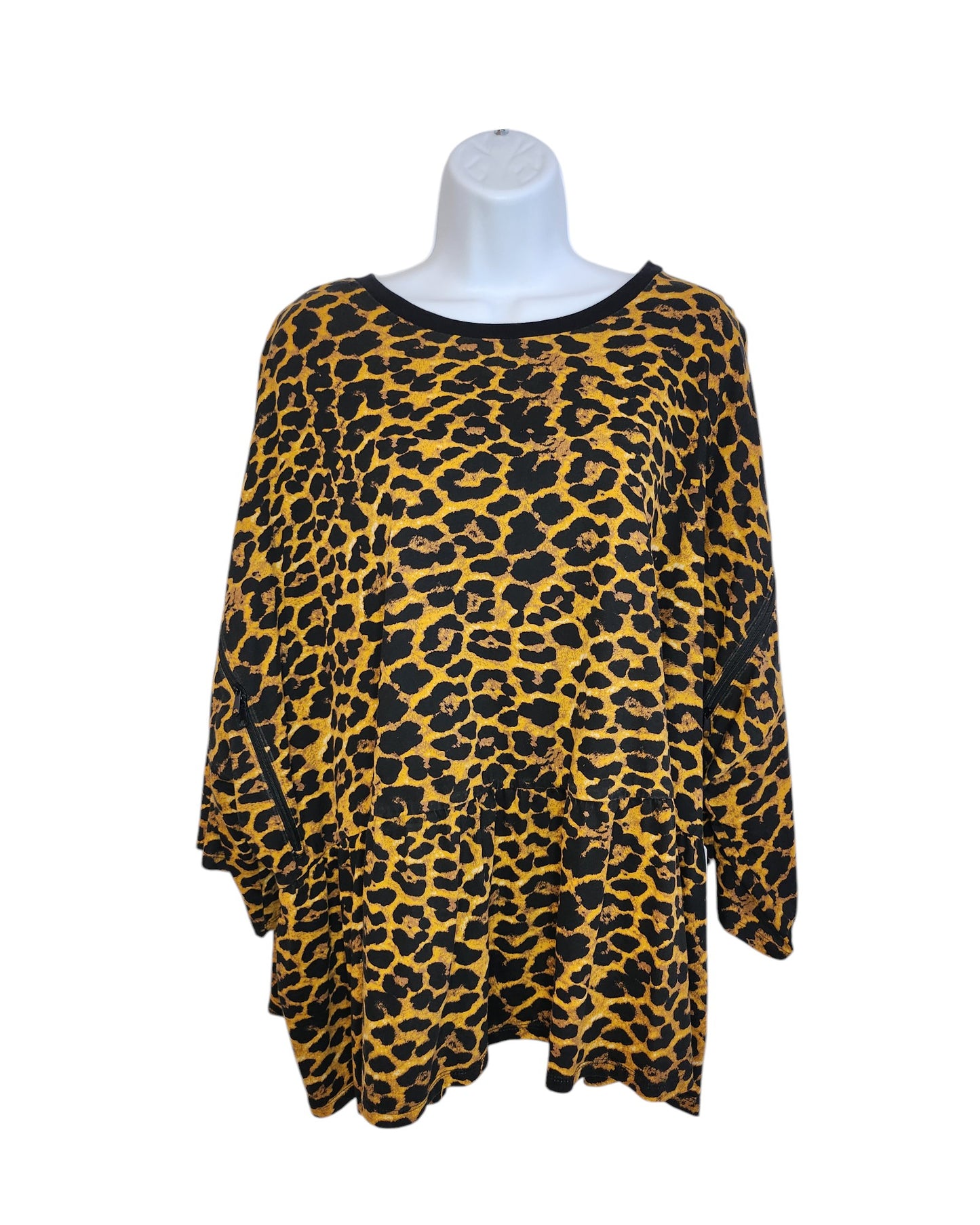 The Upcycled Breastfeeding & Pumping Cheetah T-shirt from touched out mama is a UK30 long-sleeve, loose-fitting blouse with a bold leopard print. Made from preloved clothing, it features a golden yellow base with black spots and neckline trim, merging eco-friendliness with style.