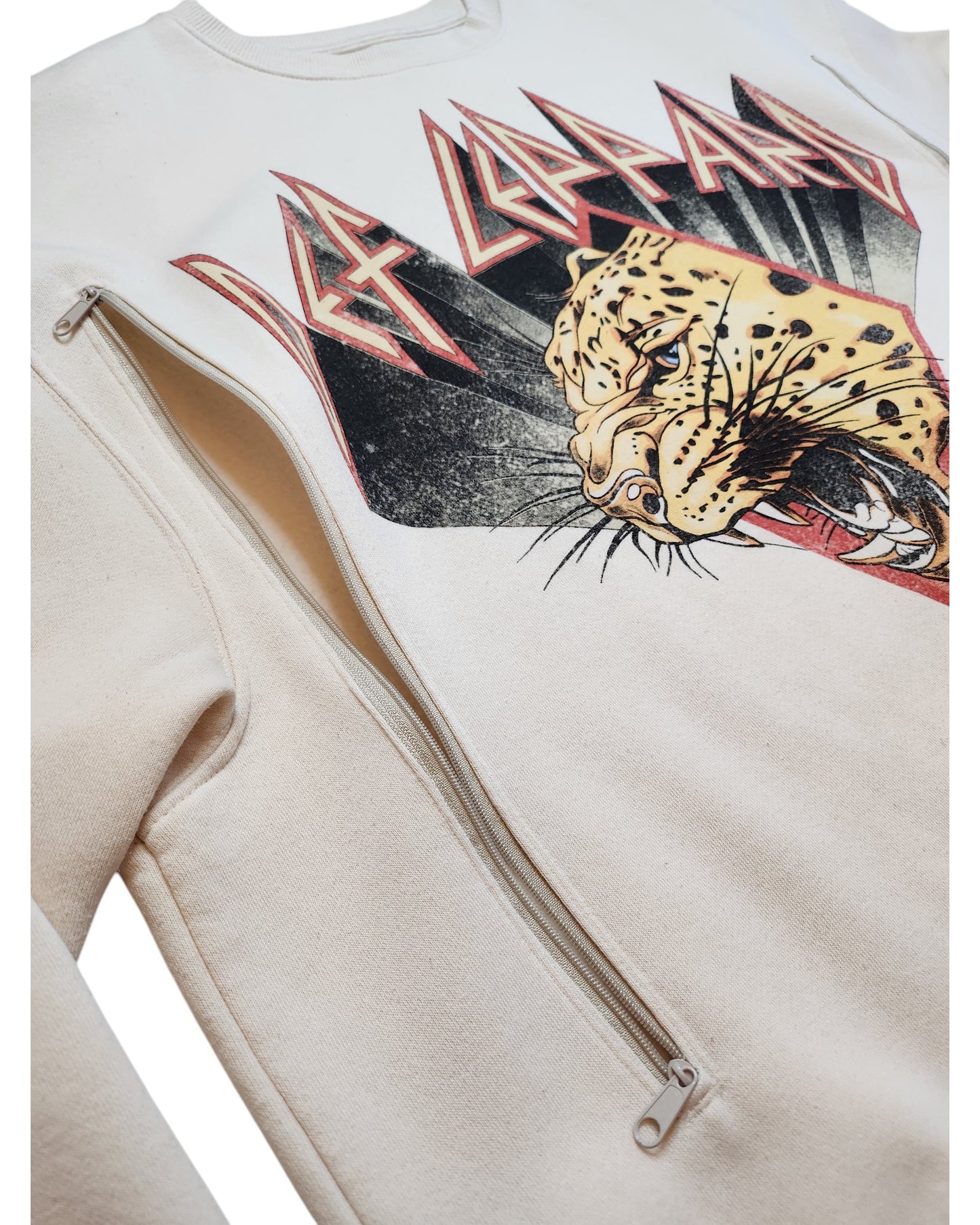 The touched out mama Upcycled Breastfeeding & Pumping Def Leppard Cream Sweatshirt features a roaring leopard graphic and stylized red and black text. This eco-friendly piece includes an innovative side zipper from armpit to hem, seamlessly blending style with practical breastfeeding design.