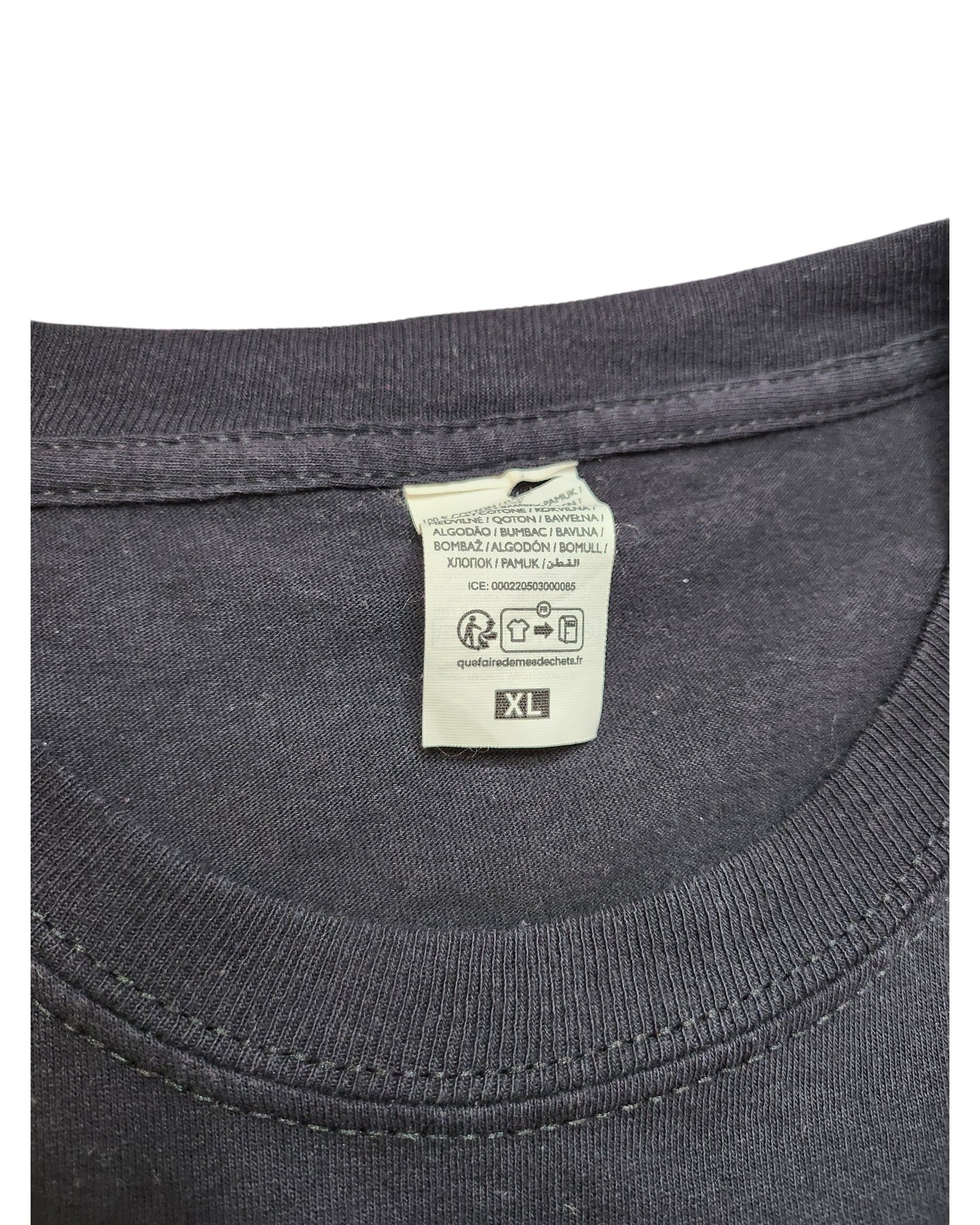 Close-up of the Upcycled Breastfeeding & Pumping Nirvana t-shirt XL by touched out mama, showing a black collar with a sewn-in label detailing care instructions and size XL in multiple languages, perfect for preloved clothing enthusiasts.