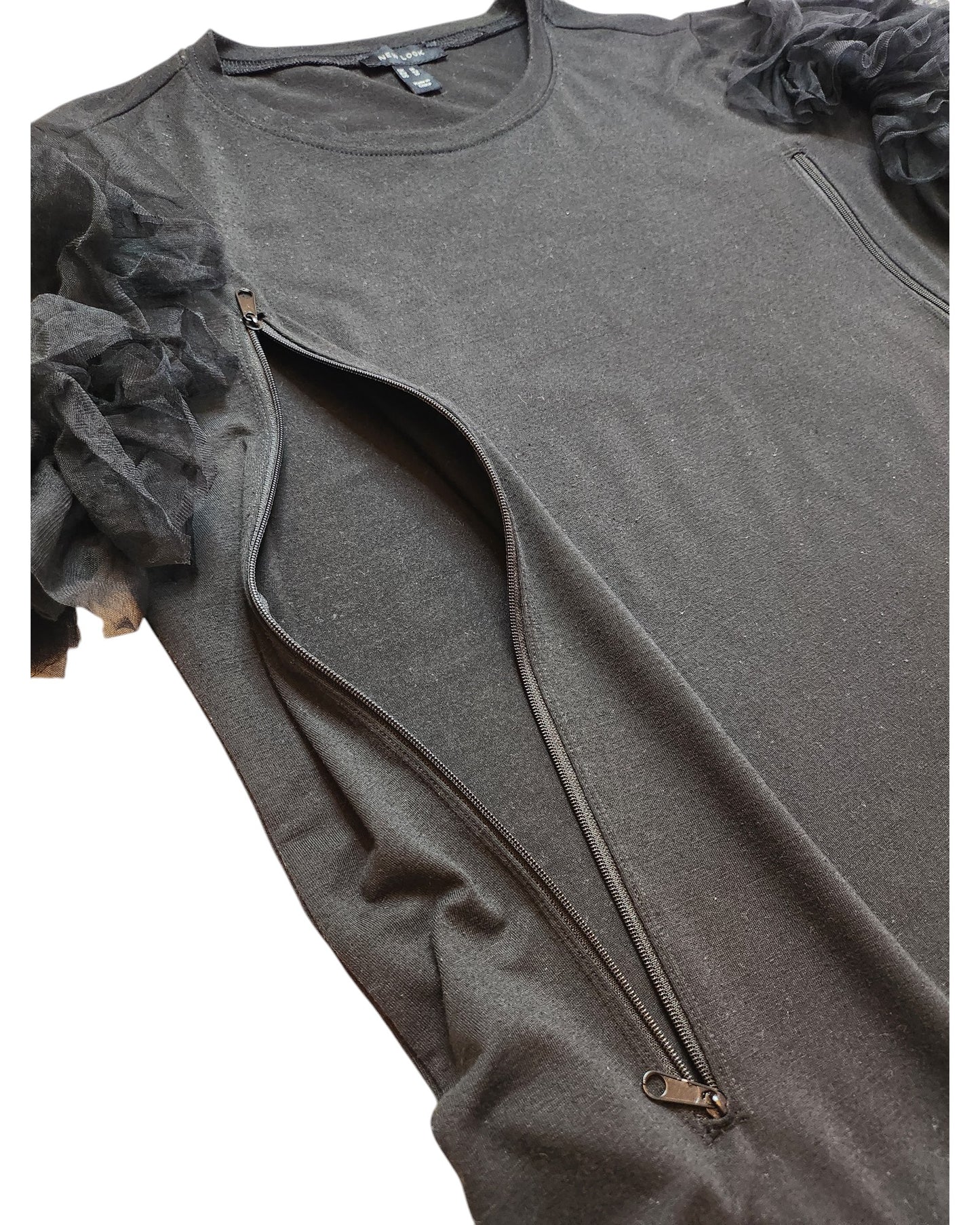 The touched out mama Upcycled Breastfeeding & Pumping Black Tulle t-shirt (UK14) combines elegance with functionality, featuring tulle ruffle shoulder details and diagonal zips from shoulder to underarm. Its shimmering finish adds glamour for the stylish mom.