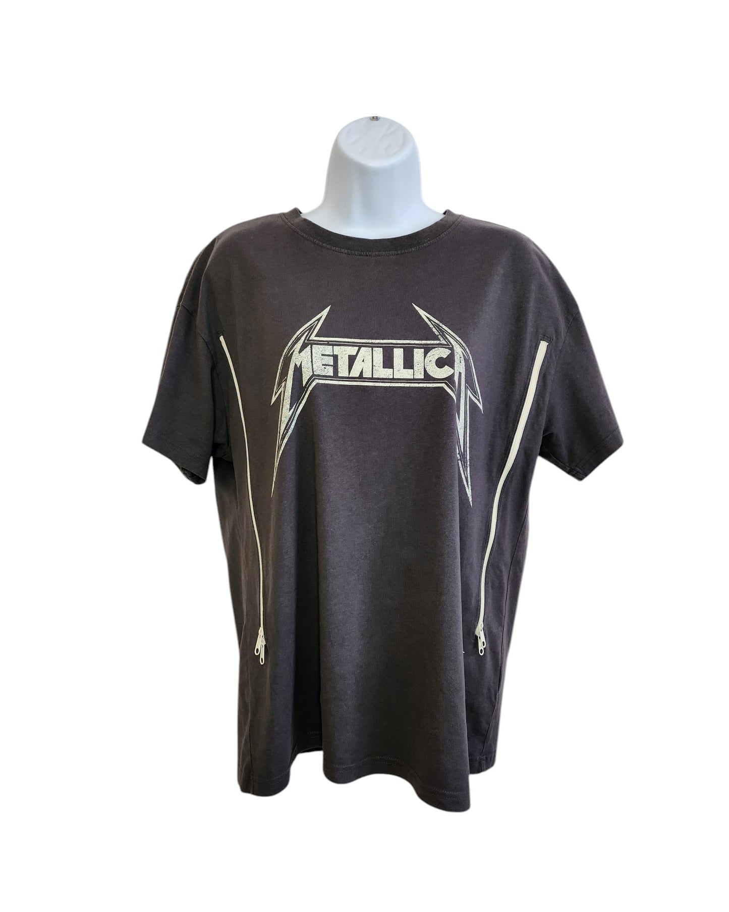 The Upcycled Breastfeeding & Pumping Metallica Grey T-shirt S by touched out mama features a bold logo and side zippers, displayed on a white mannequin torso against a plain background, merging edgy style with sustainable fashion.