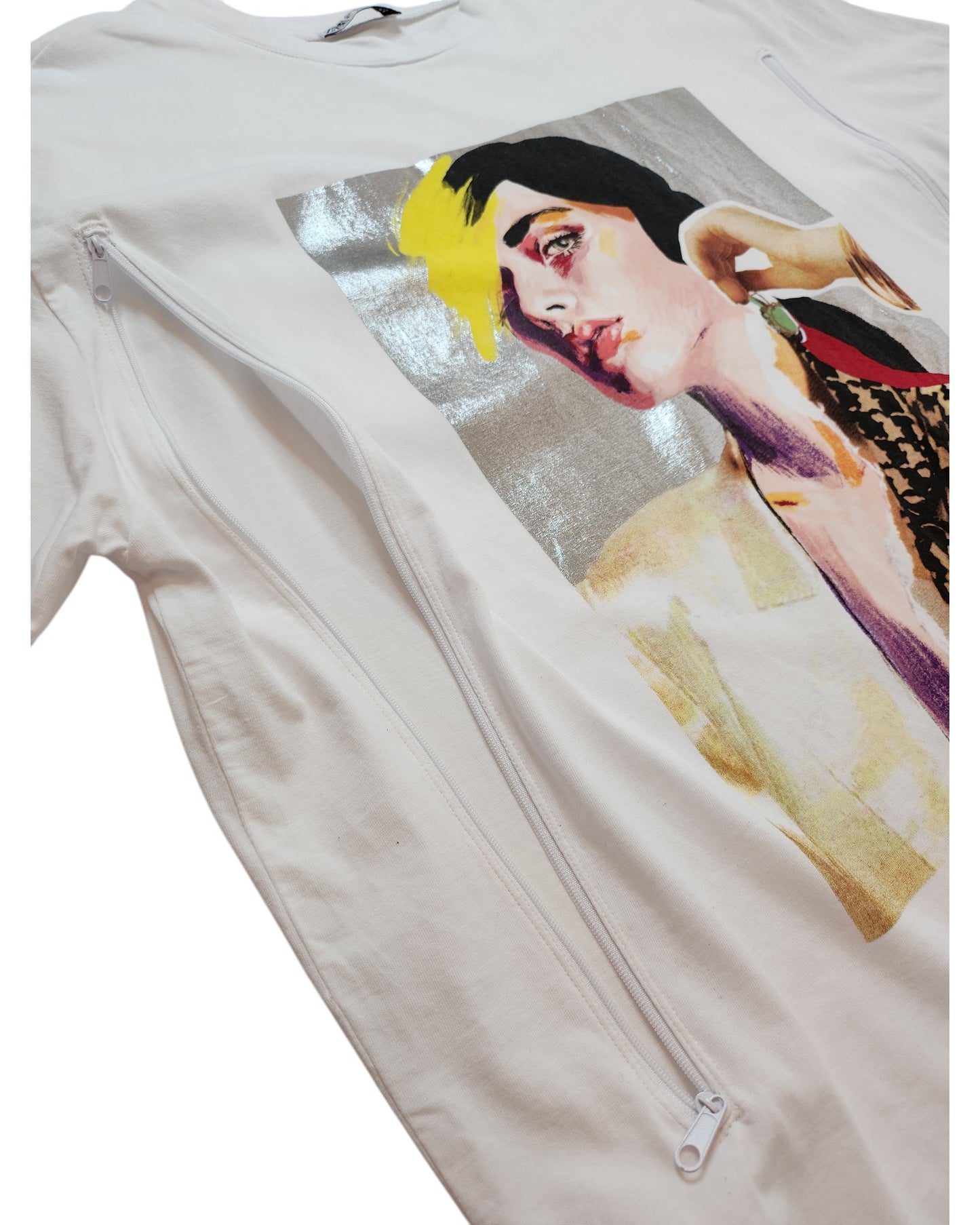 The Upcycled Breastfeeding & Pumping Silver Face T-shirt by touched out mama is a white tee with a colorful abstract portrait in yellow, black, and peach tones. Featuring upcycled elements and diagonal zippers, it uniquely combines style with eco-friendly fashion.