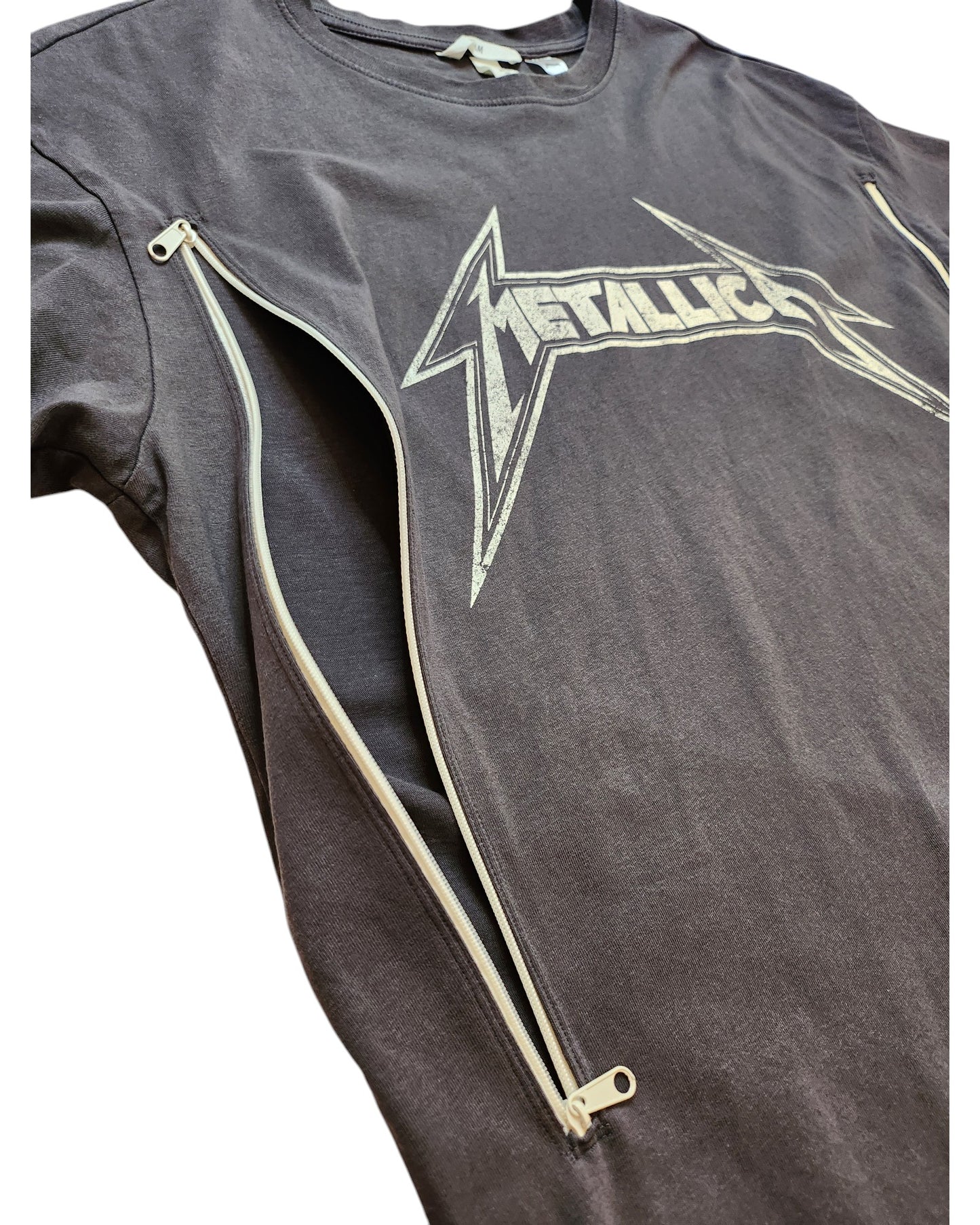 The Upcycled Breastfeeding & Pumping Metallica Grey T-shirt S by touched out mama features a stylized band logo with vertical side zippers, highlighting its unique eco-friendly design.
