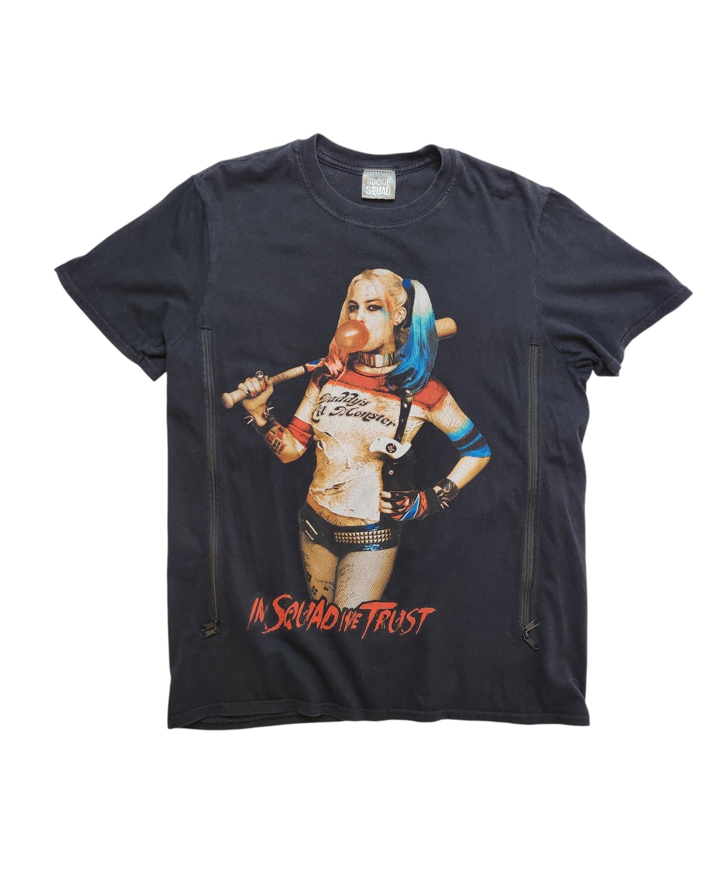 This upcycled UK12 T-shirt from touched out mama features Harley Quinn with blonde and pink hair, a crop top, and shorts, holding a baseball bat. In Squad We Trust is printed on it, highlighting sustainable style through preloved fashion.