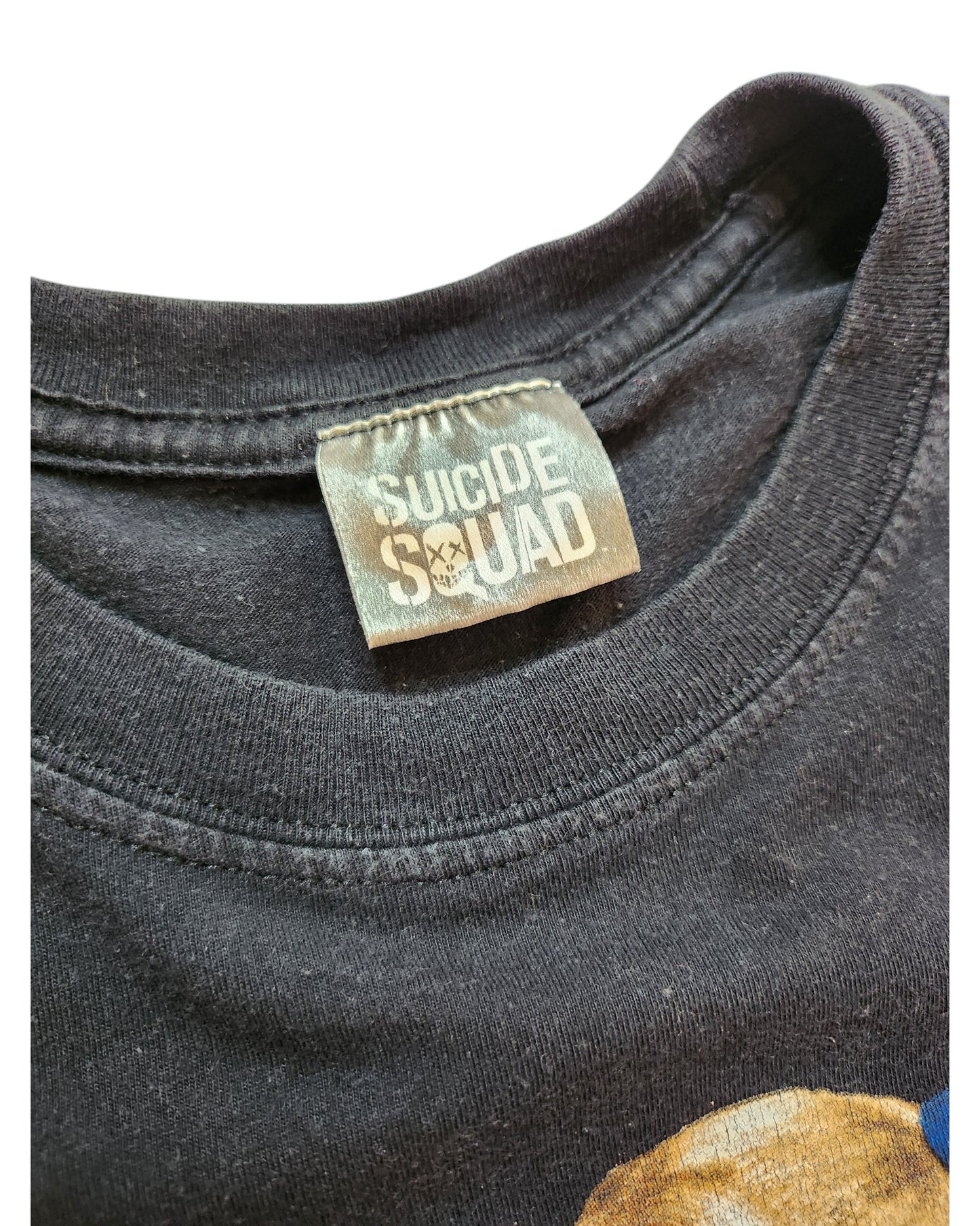 Close-up of a black Upcycled Breastfeeding & Pumping Harley Quinn t-shirt by touched out mama, UK12. This preloved item highlights worn fabric and visible neckline stitching under the collar, featuring a unique skull emblem that adds character to its charm.