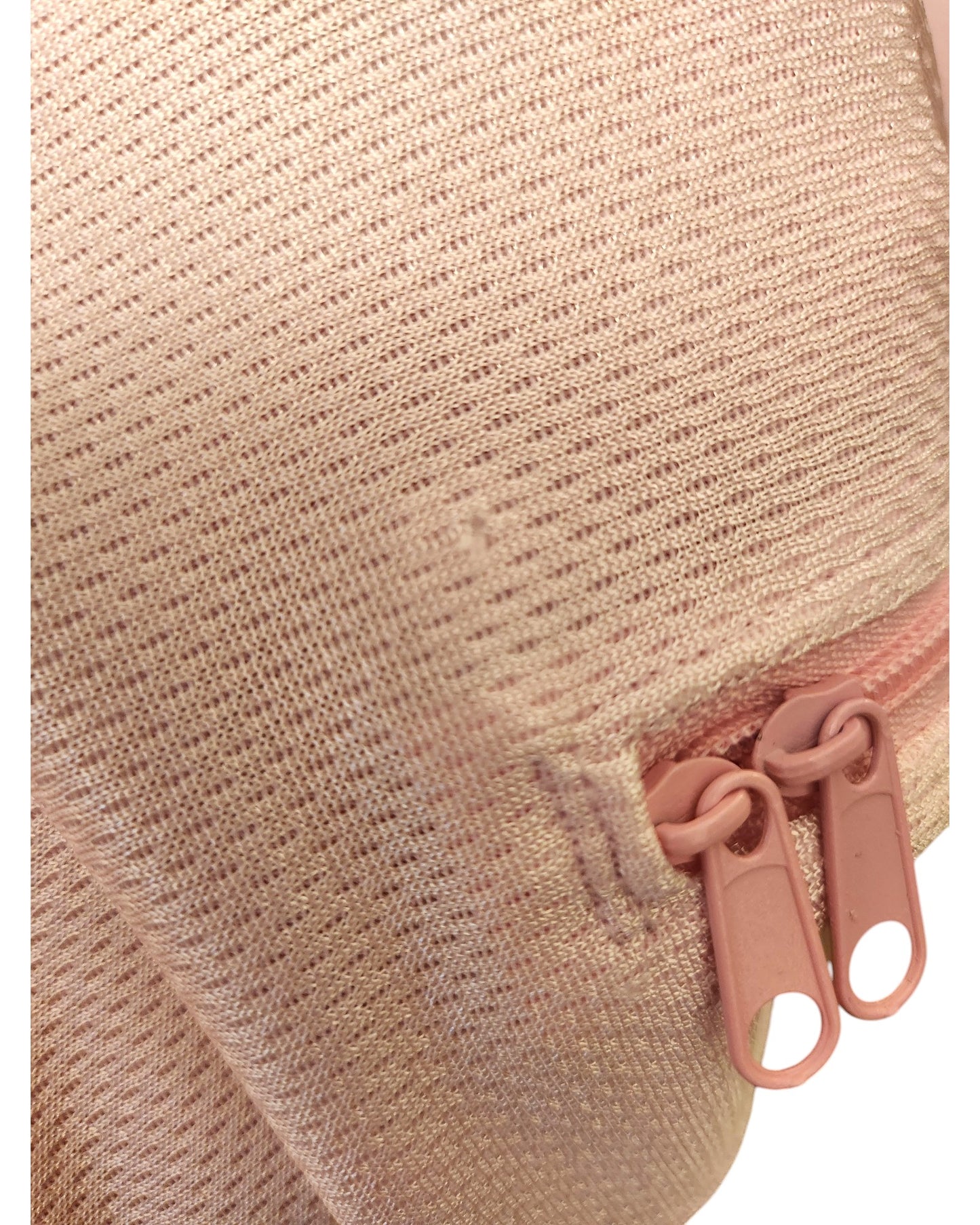 Close-up of an H&M Upcycled Breastfeeding & Pumping Football Jersey XL, with textured metallic pink fabric and two pink zipper pulls—crafted from preloved clothing for eco-friendly style.