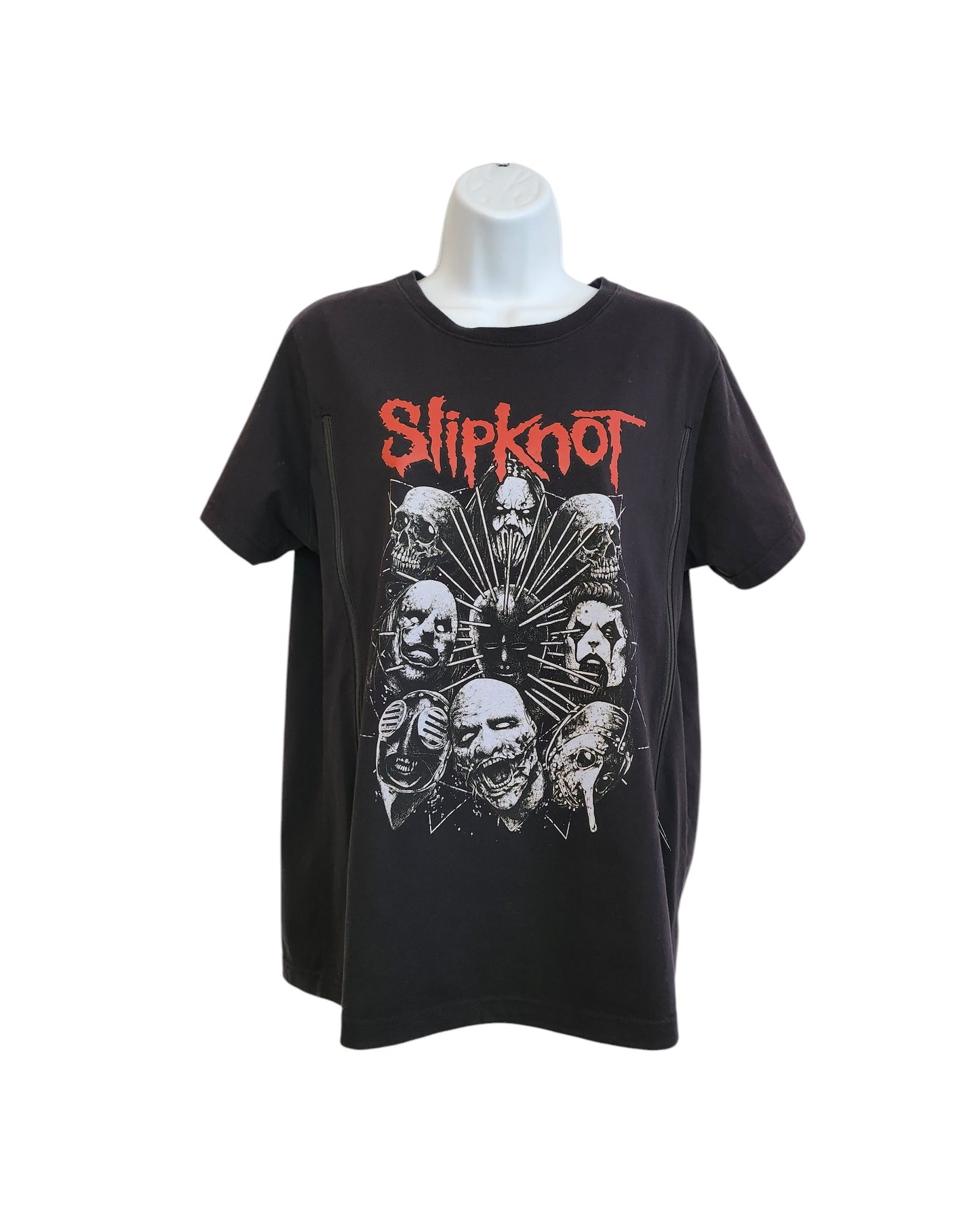 This upcycled large Slipknot T-shirt by touched out mama, displaying the bands masked faces in a circle and Slipknot in red text, offers edgy style with sustainable fashion. Modeled on a mannequin against a white backdrop, its an eco-friendly choice for breastfeeding fans.