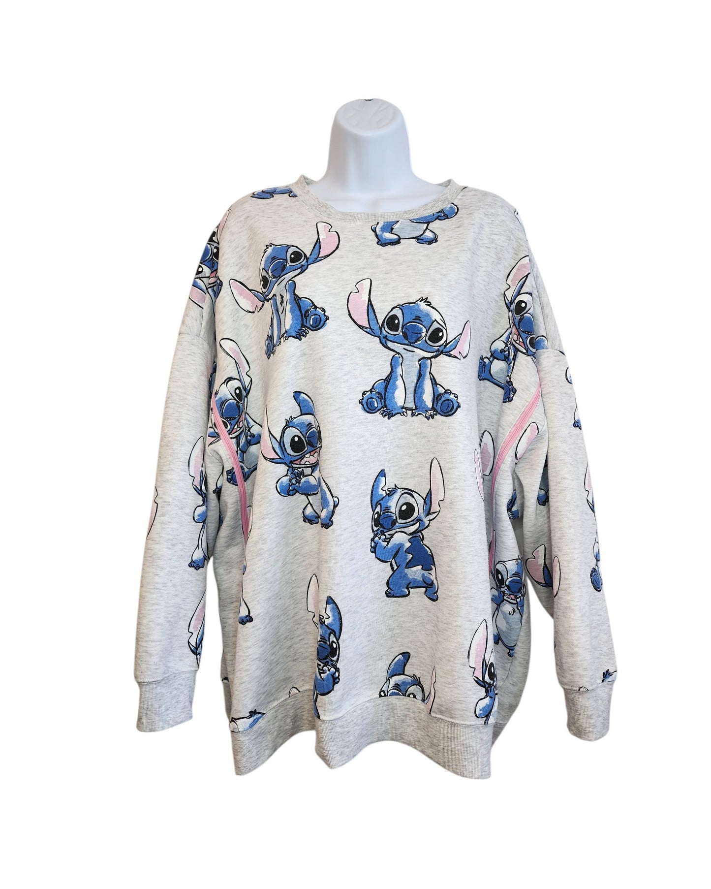 A light gray 2XL Primark sweatshirt, upcycled for breastfeeding and pumping, features playful cartoon Stitch images from Disney’s Lilo & Stitch. Displayed on a white mannequin torso.