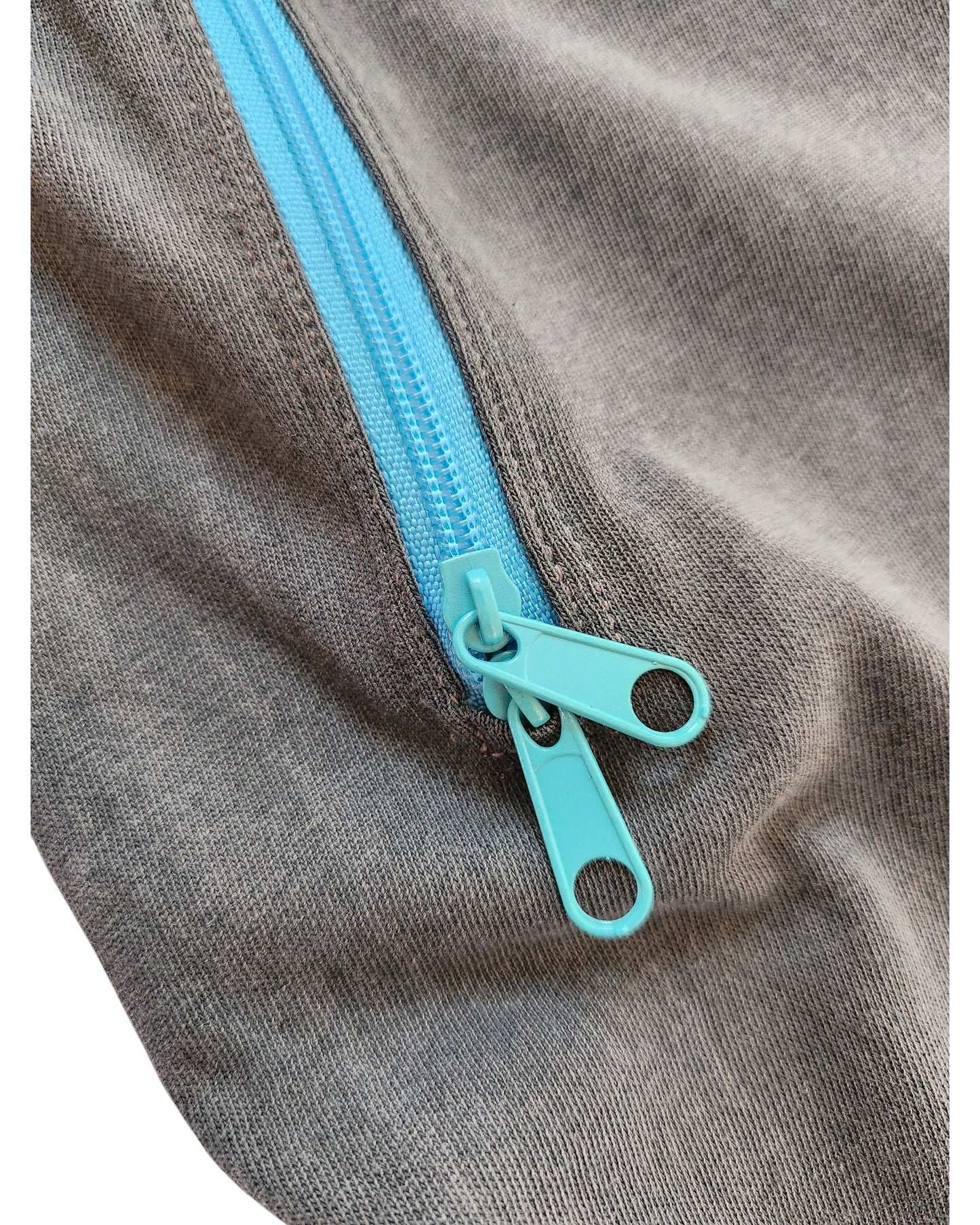 Close-up of a blue zipper with two pulls on grey fabric, slightly opened to show the teeth—featured on the touched out mama Upcycled Breastfeeding & Pumping Garfield t-shirt Dress M for easy nursing access in preloved clothing.