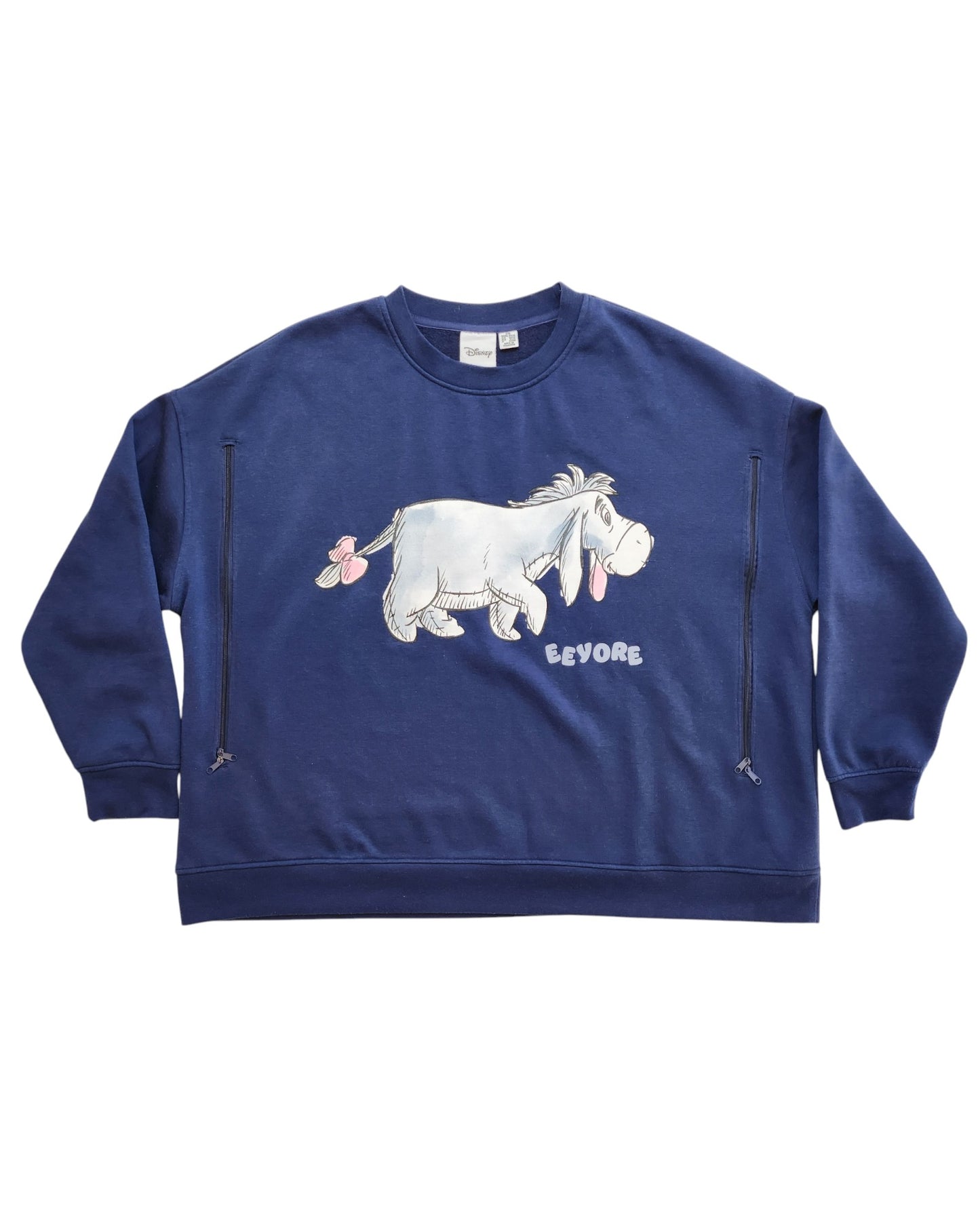The Primark Upcycled Breastfeeding & Pumping Eeyore Disney Sweatshirt (2XL) features a graphic of Eeyore with his name printed below—an eco-friendly, cozy choice for nursing moms and Disney fans.