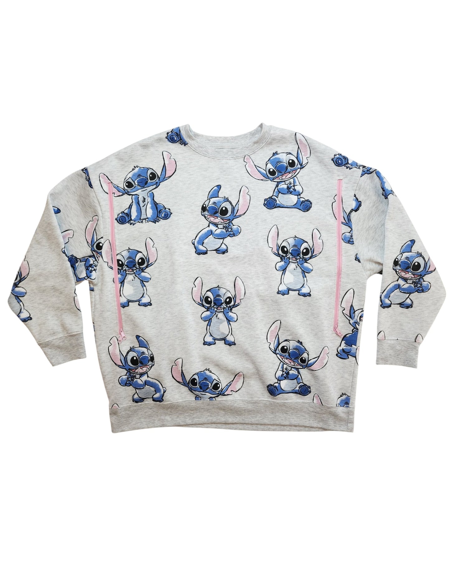 The touched out mama Upcycled Breastfeeding & Pumping Stitch Disney Sweatshirt (M) is a light gray preloved top with cute all-over Stitch prints, designed with long sleeves and a crew neckline for comfort and timeless style.