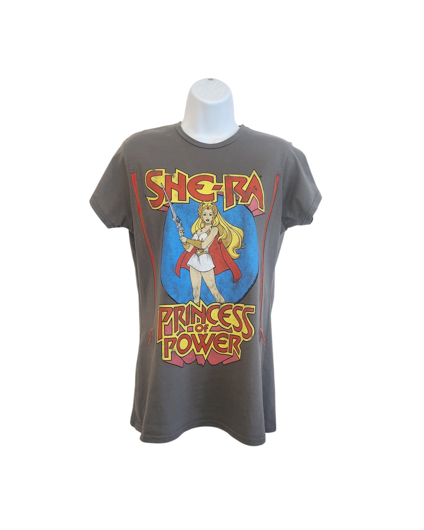 The touched out mamas upcycled nursing & pumping T-shirt in gray boasts a vibrant She-Ra graphic with She-Ra Princess of Power in red and yellow, combining iconic style with sustainability. Available on a mannequin, its a unique nod to eco-friendly fashion.