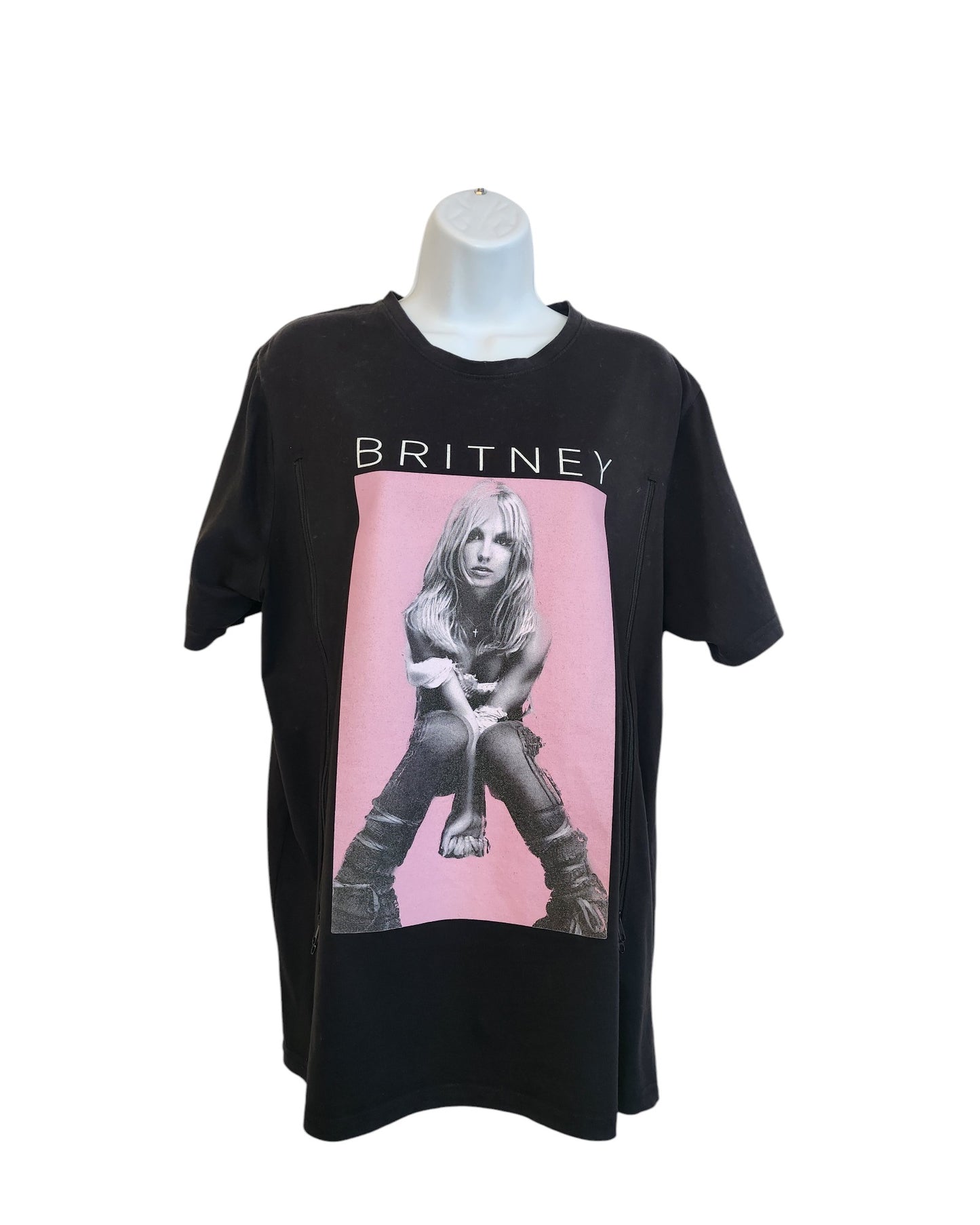 Displayed on a mannequin, the Upcycled Breastfeeding & Pumping Britney T-shirt by touched out mama features a pink-toned photo of a seated woman with BRITNEY above, blending style and sustainability in this chic, preloved piece.