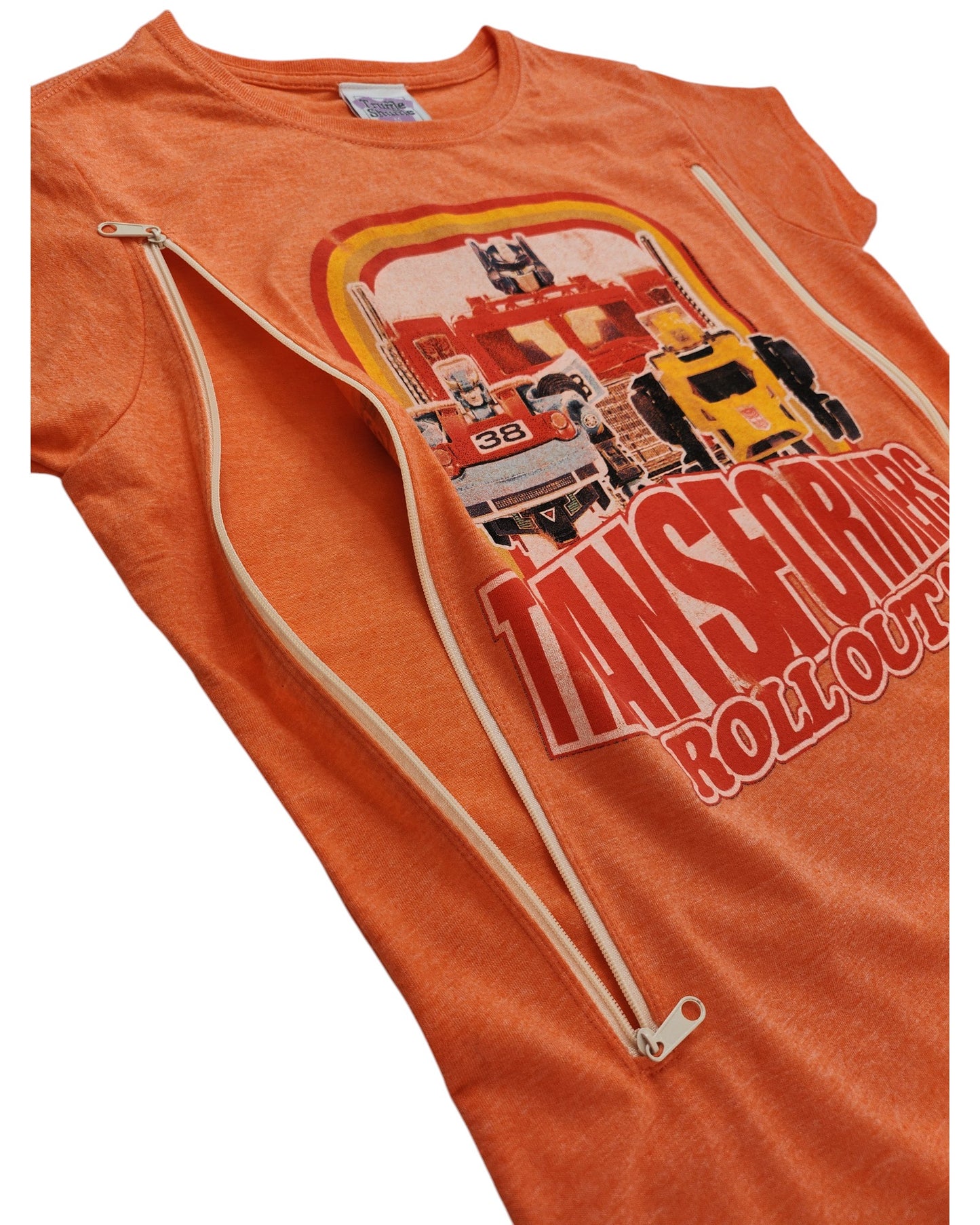 Truffle Shuffle’s Upcycled Breastfeeding & Pumping Orange Transformers T-shirt (M) features “Transformers Roll Out!” text, two diagonal zippers from neck to underarm, and a stylish design for nursing moms.