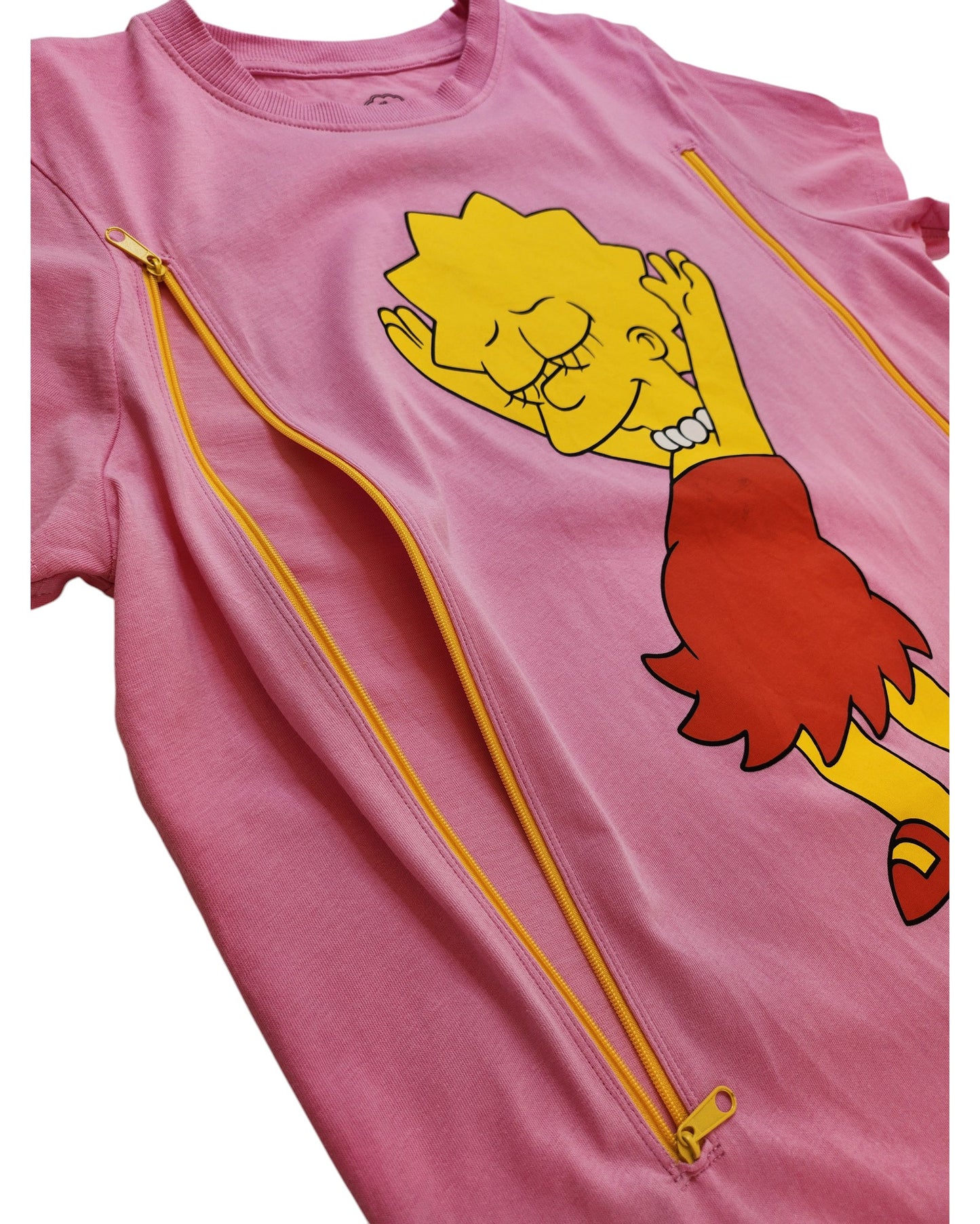 The touched out mama Upcycled Breastfeeding & Pumping Lisa Simpson t-shirt in preloved pink, size M, displays Lisa with a yellow face, red dress, and closed-eye smile. It includes two vertical yellow zippers for convenient breastfeeding access.