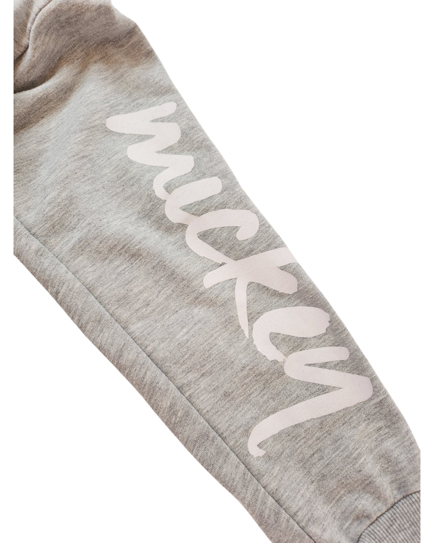 A close-up of a gray sleeve on the Upcycled Breastfeeding & Pumping Minnie & Mickey Sweatshirt UK14 by touched out mama showcases Mickey in white cursive. The soft fabric hints at sweatshirt material from Disney preloved clothes, adding an eco-friendly touch to any wardrobe.