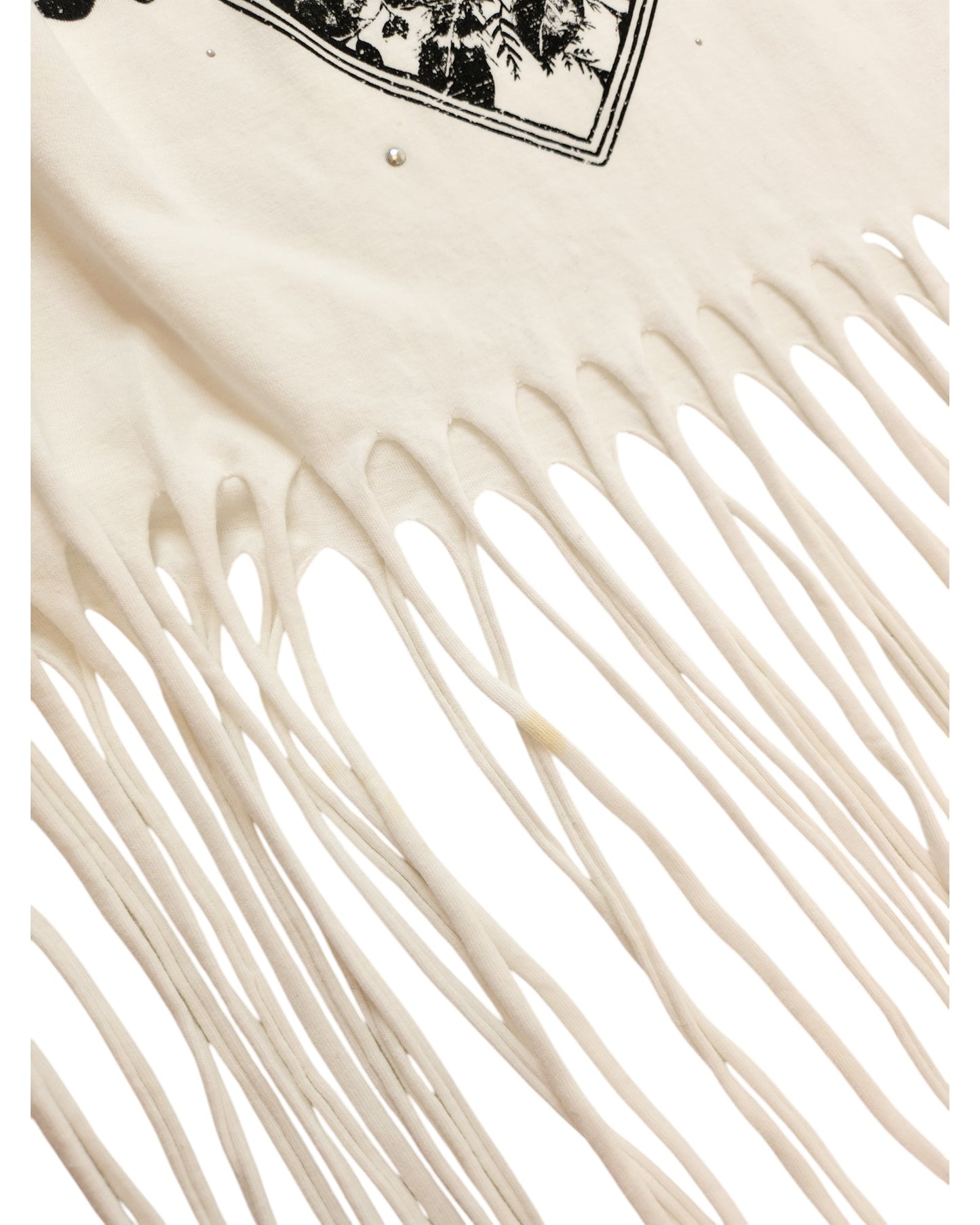 A close-up of the Upcycled Breastfeeding & Pumping Festival Fringing T-shirt M by touched out mama, crafted from preloved nursing wear. This eco-friendly garment features a detailed long fringe design and a partial printed pattern at its top edge.