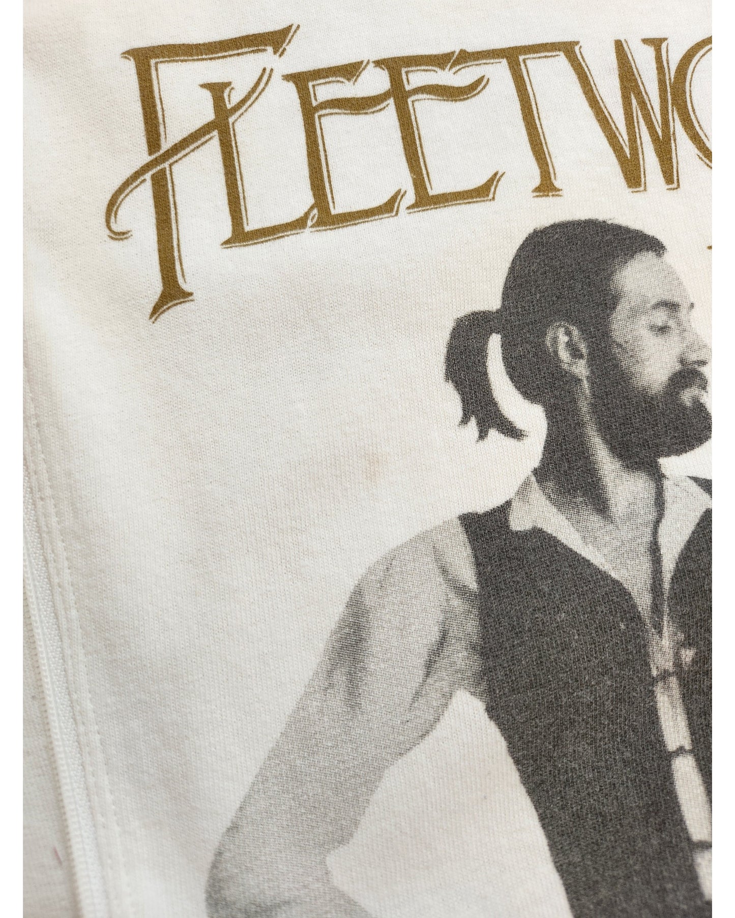 Close-up of touched out mamas Upcycled Breastfeeding & Pumping Fleetwood Mac White t-shirt (M) featuring gold Fleetwood text and a black-and-white image of a bearded, ponytailed man in a vest and shirt.