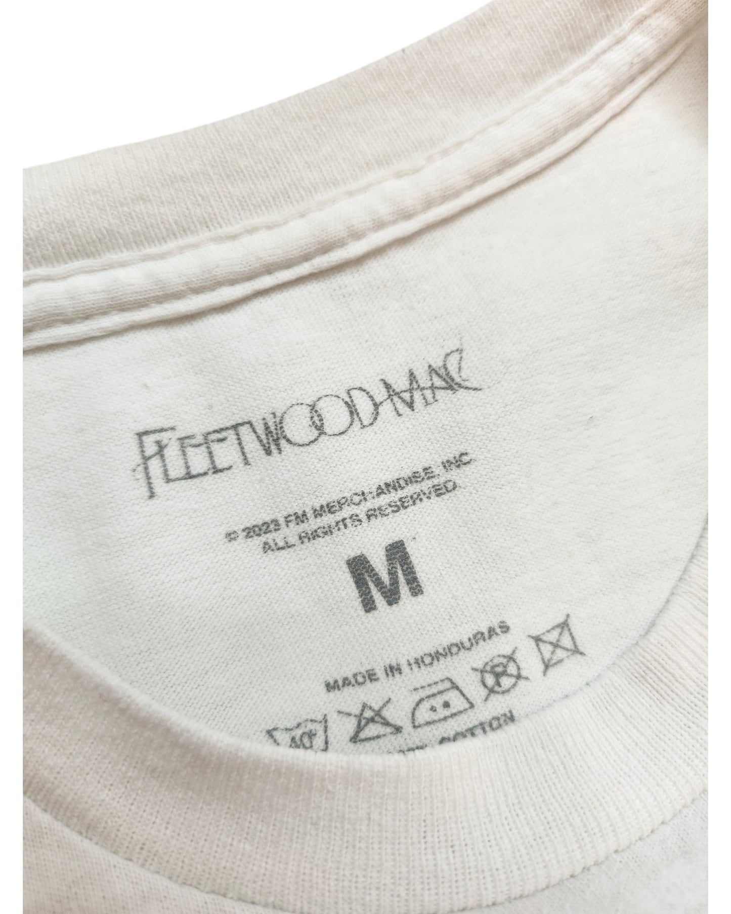 Close-up of the Upcycled Breastfeeding & Pumping Fleetwood Mac White T-shirt (M) by touched out mama, featuring neckline and tag details—crafted from sustainable materials for eco-conscious fans.