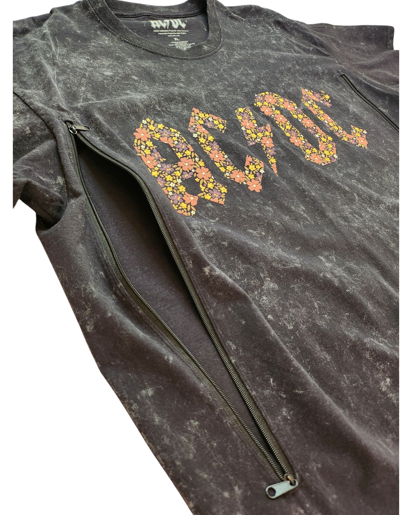 The Upcycled Breastfeeding (Nursing) & Pumping Floral AC/DC T-shirt XL by touched out mama is a black tee adorned with a colorful floral AC/DC design and two vertical zippers, crafted from upcycled material, offering a unique eco-friendly fashion statement.