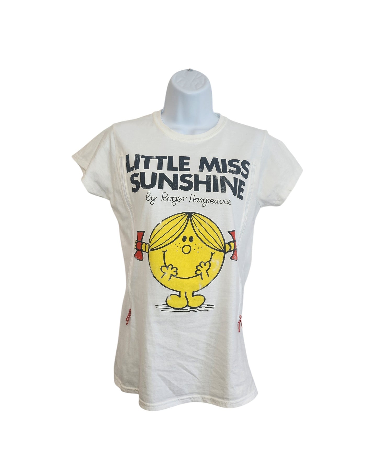 A white upcycled Truffle Shuffle t-shirt (size M) for breastfeeding and pumping features Little Miss Sunshine with yellow skin, blonde pigtails, and red bows—an adorable preloved piece inspired by Roger Hargreaves.