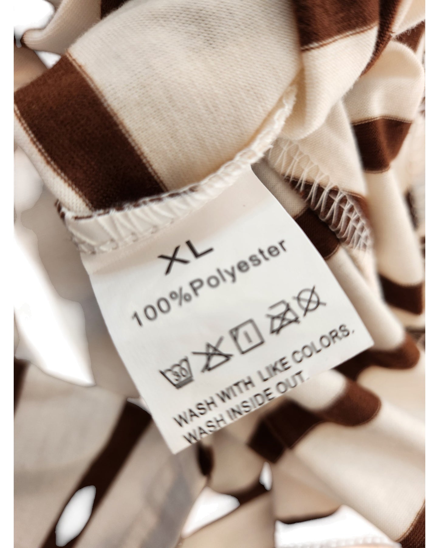 Close-up of TikToks Upcycled Breastfeeding & Pumping Cream/Brown Stripe t-shirt dress label, size XL, 100% polyester—preloved for sustainable style.