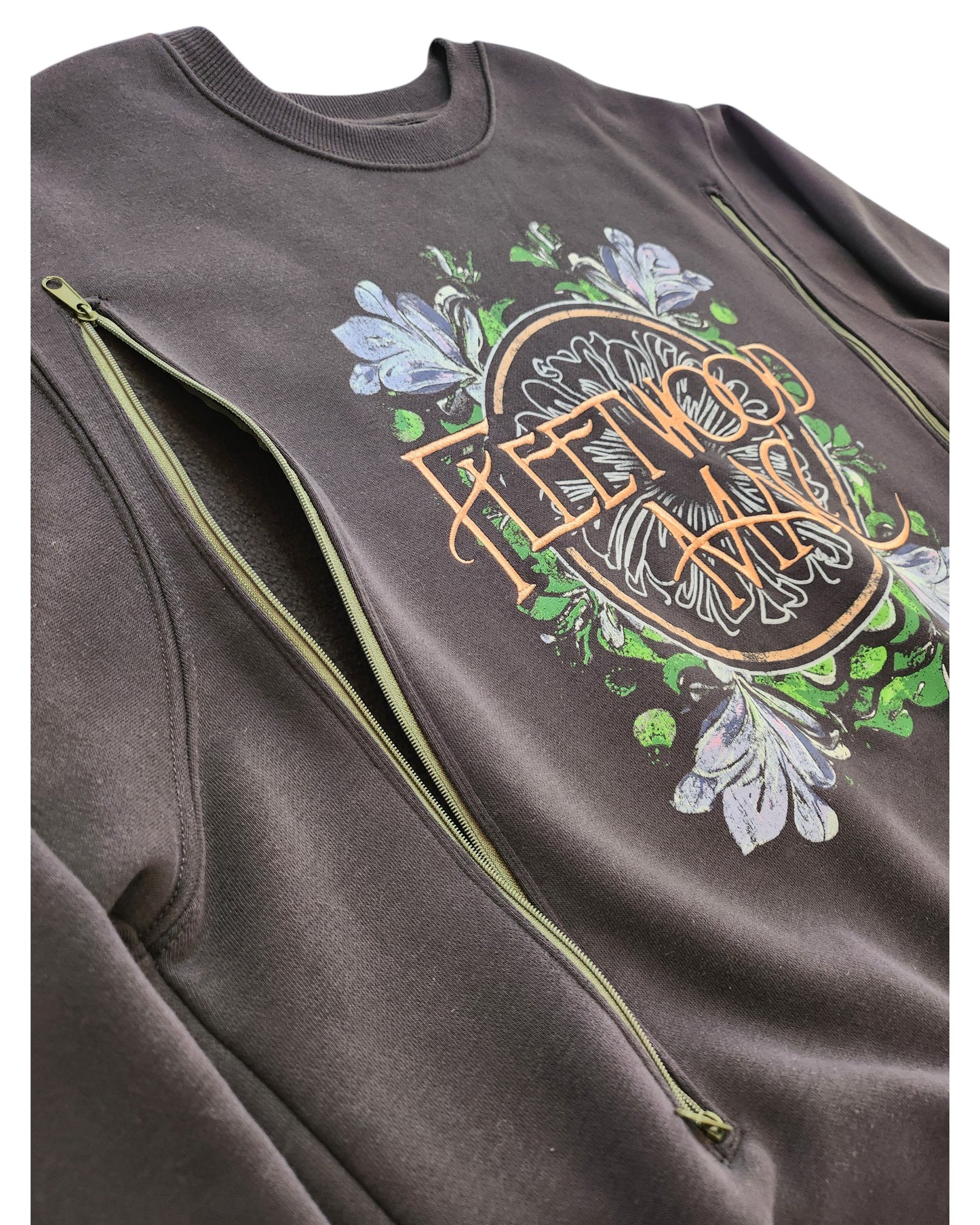 Close-up of Primarks upcycled grey Fleetwood Mac embroidered band sweatshirt (M), featuring eco-friendly diagonal zippers for breastfeeding or pumping, blending style with practical nursing access.