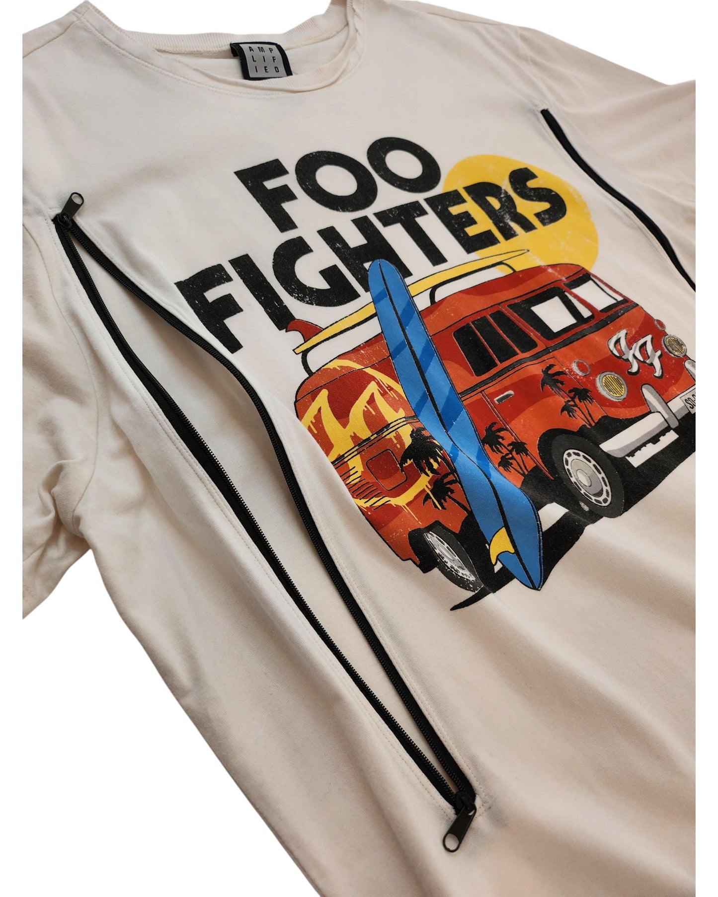 The Amplified Upcycled Breastfeeding & Pumping Foo Fighters t-shirt (XL) features a cream color, Foo Fighters text above a red vintage van with palm trees and sun, plus two black diagonal zippers for easy nursing and an upcycled touch.