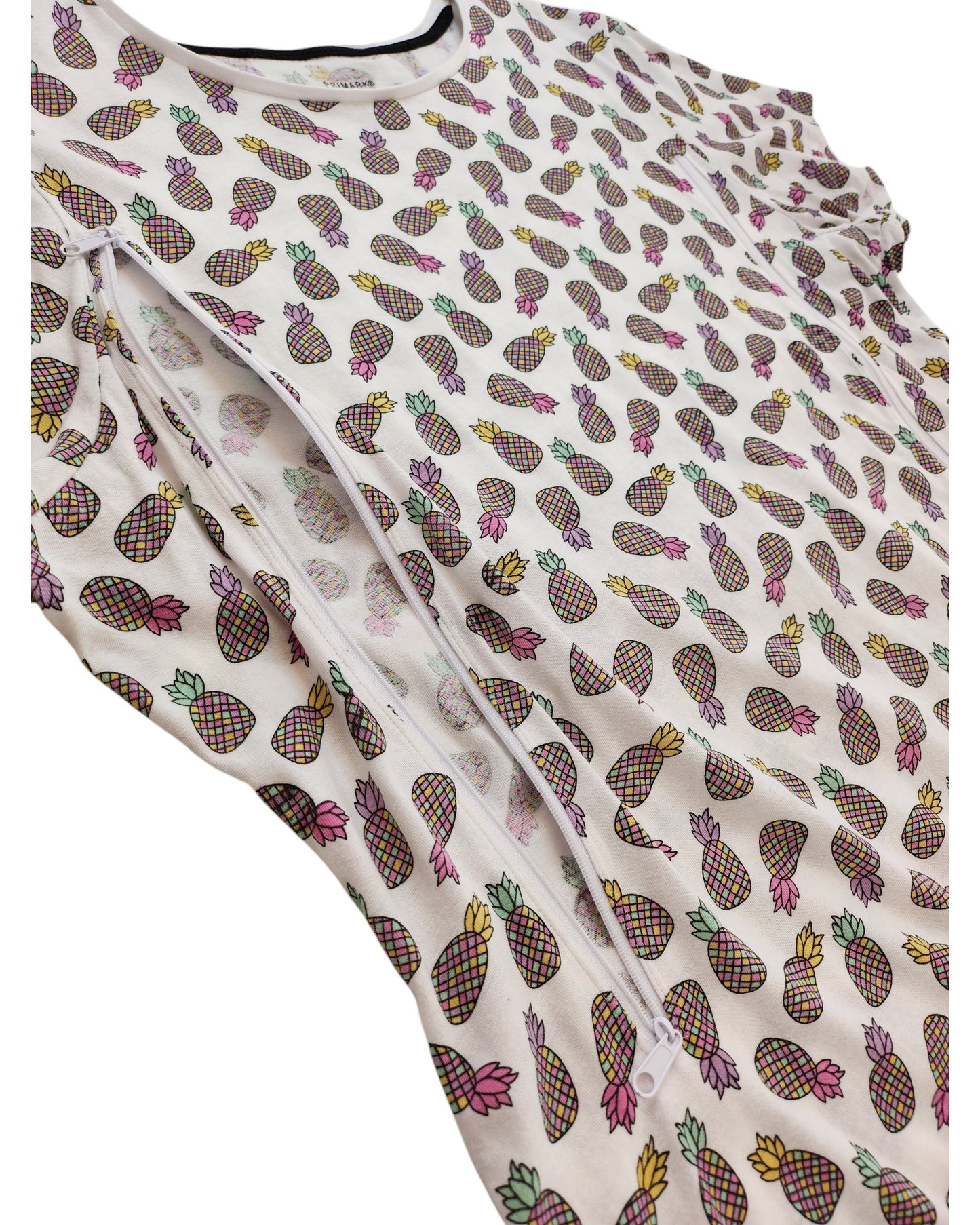 The Primark Upcycled Breastfeeding & Pumping Pineapple t-shirt UK20 is a white top with a colorful pineapple print and diagonal zipper, made from preloved clothing for an eco-friendly alternative.