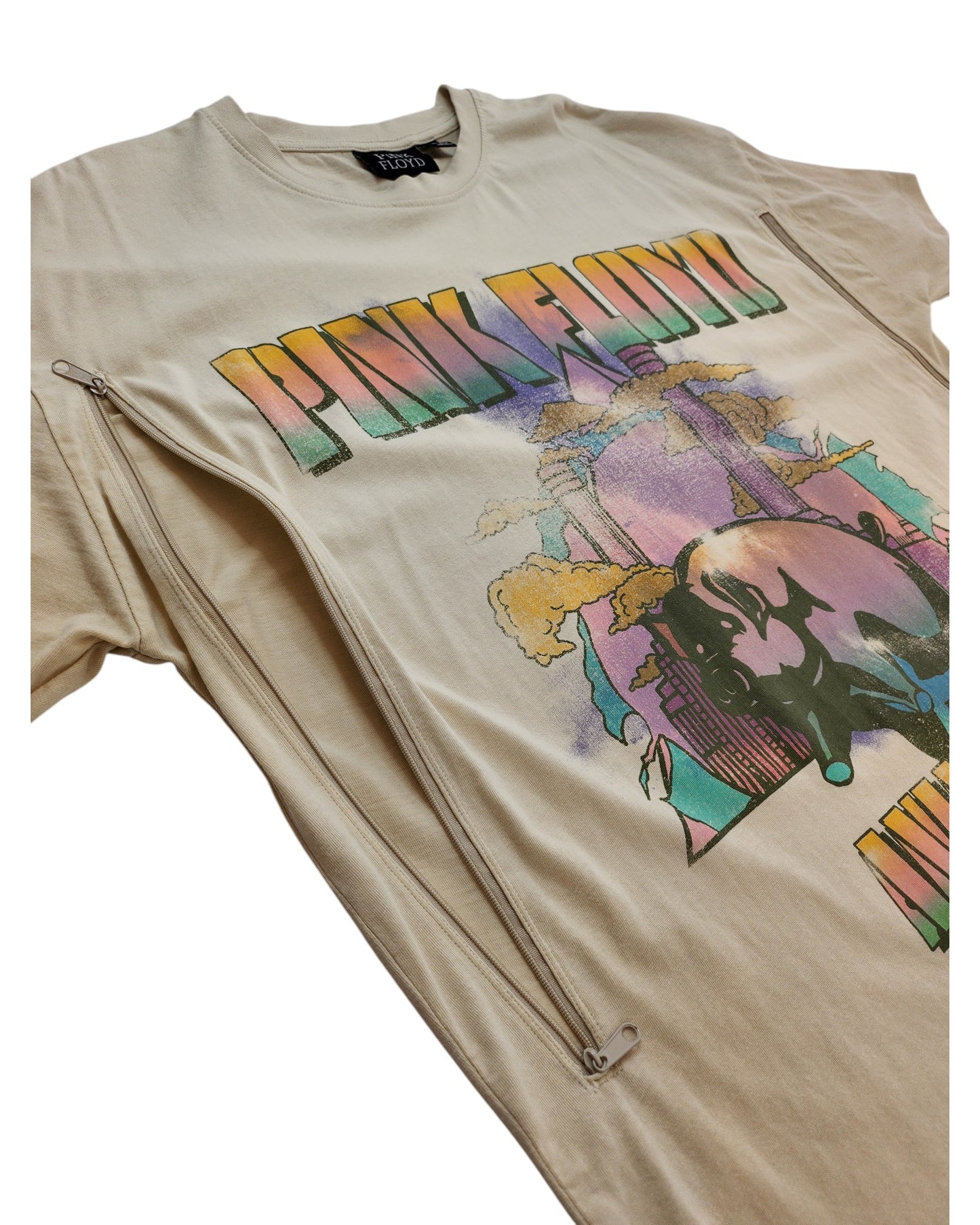 A cream Pink Floyd band T-shirt by Primark (UK12/14), upcycled for breastfeeding and pumping, features colorful artwork, text, and two diagonal zippers—ideal for a unique nursing look.