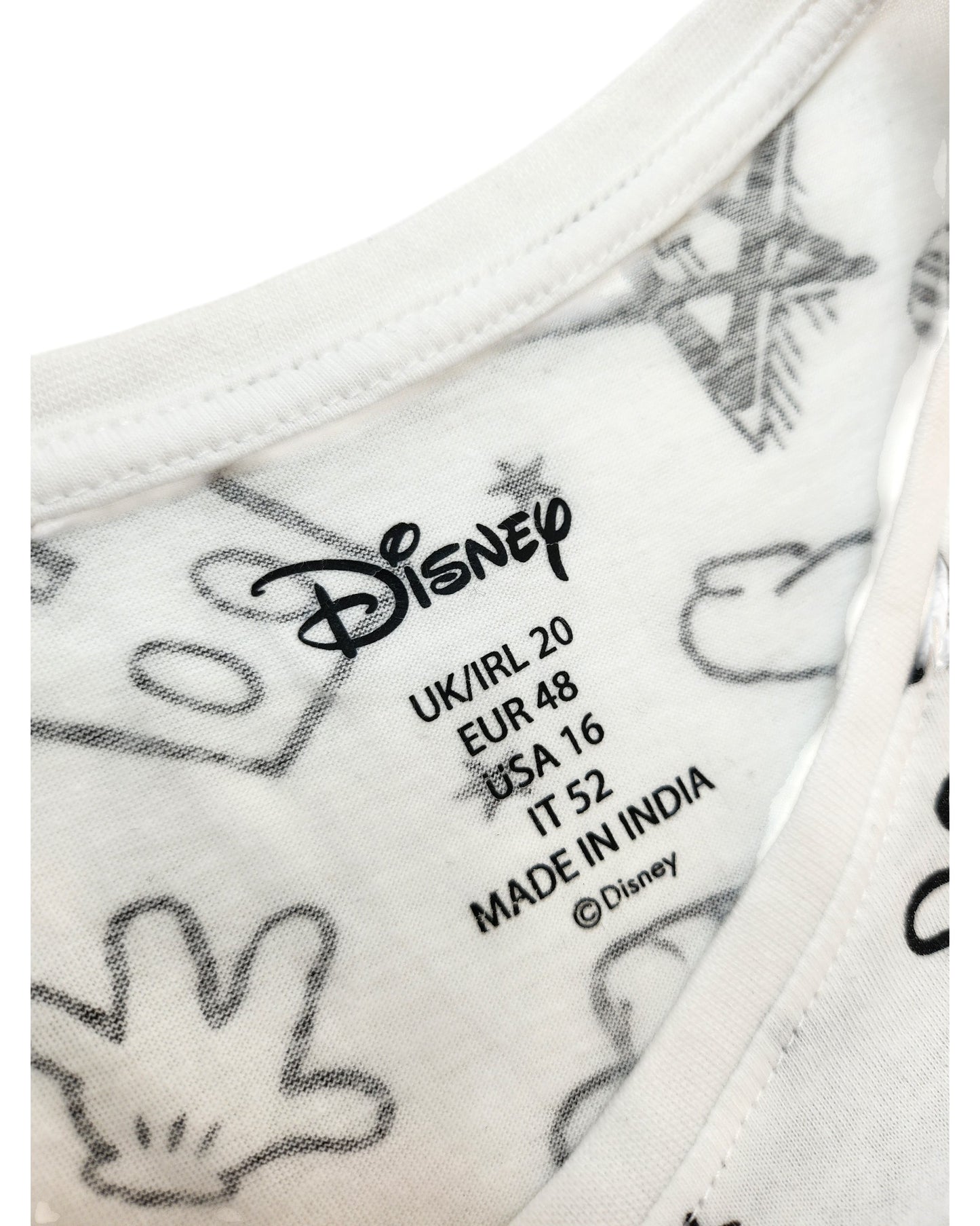 Close-up of a white Upcycled Breastfeeding & Pumping Mickey Mouse t-shirt by Primark, UK20, with black branding and size info printed inside. Features Mickey Mouse glove and star patterns. Made in India.