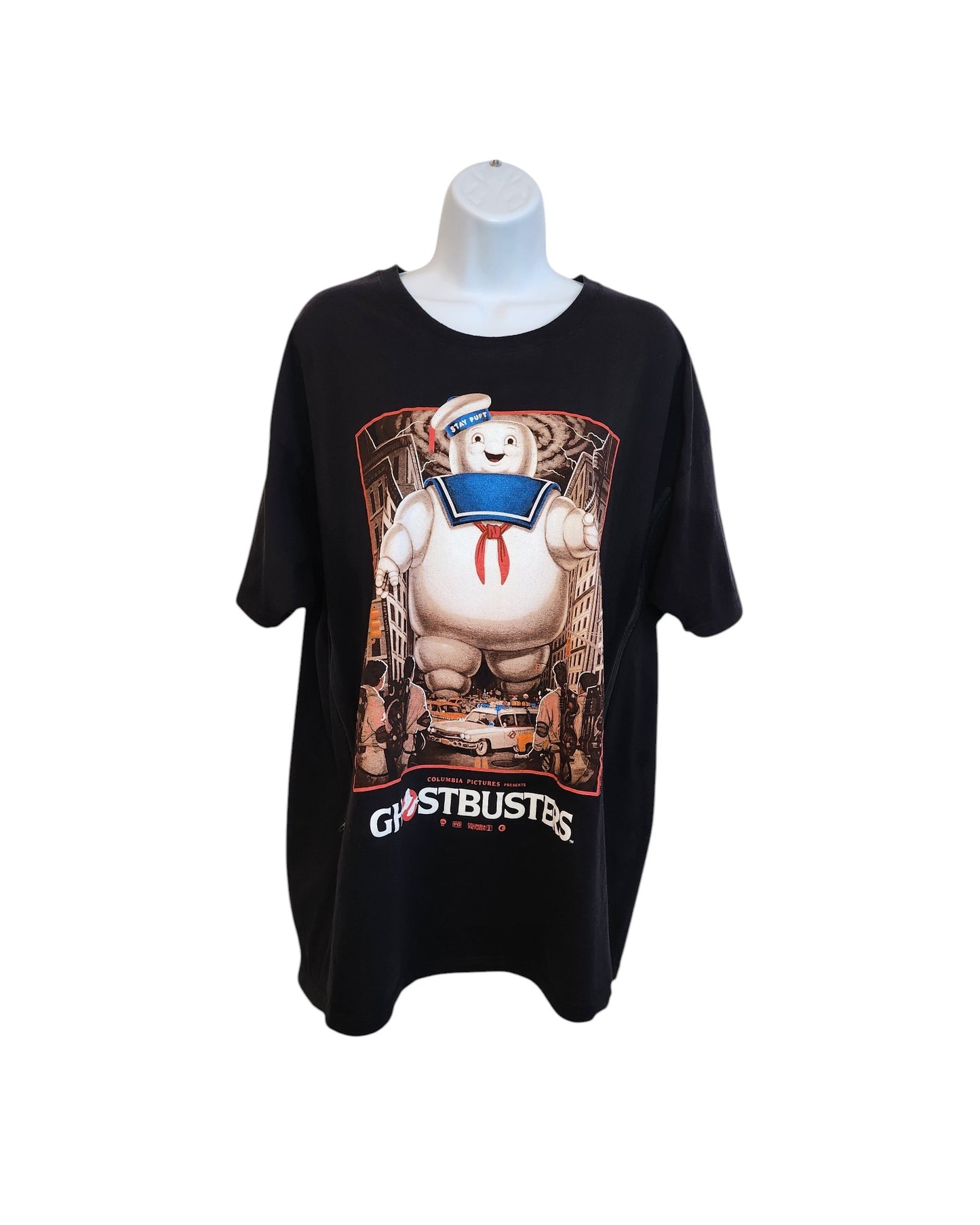 Upcycled Ghostbusters XXL breastfeeding & pumping t-shirt displayed on a mannequin with Stay Puft Marshmallow Man graphic, cityscape and characters in the background, and GHOSTBUSTERS at the bottom. Brand: Ghostbusters.