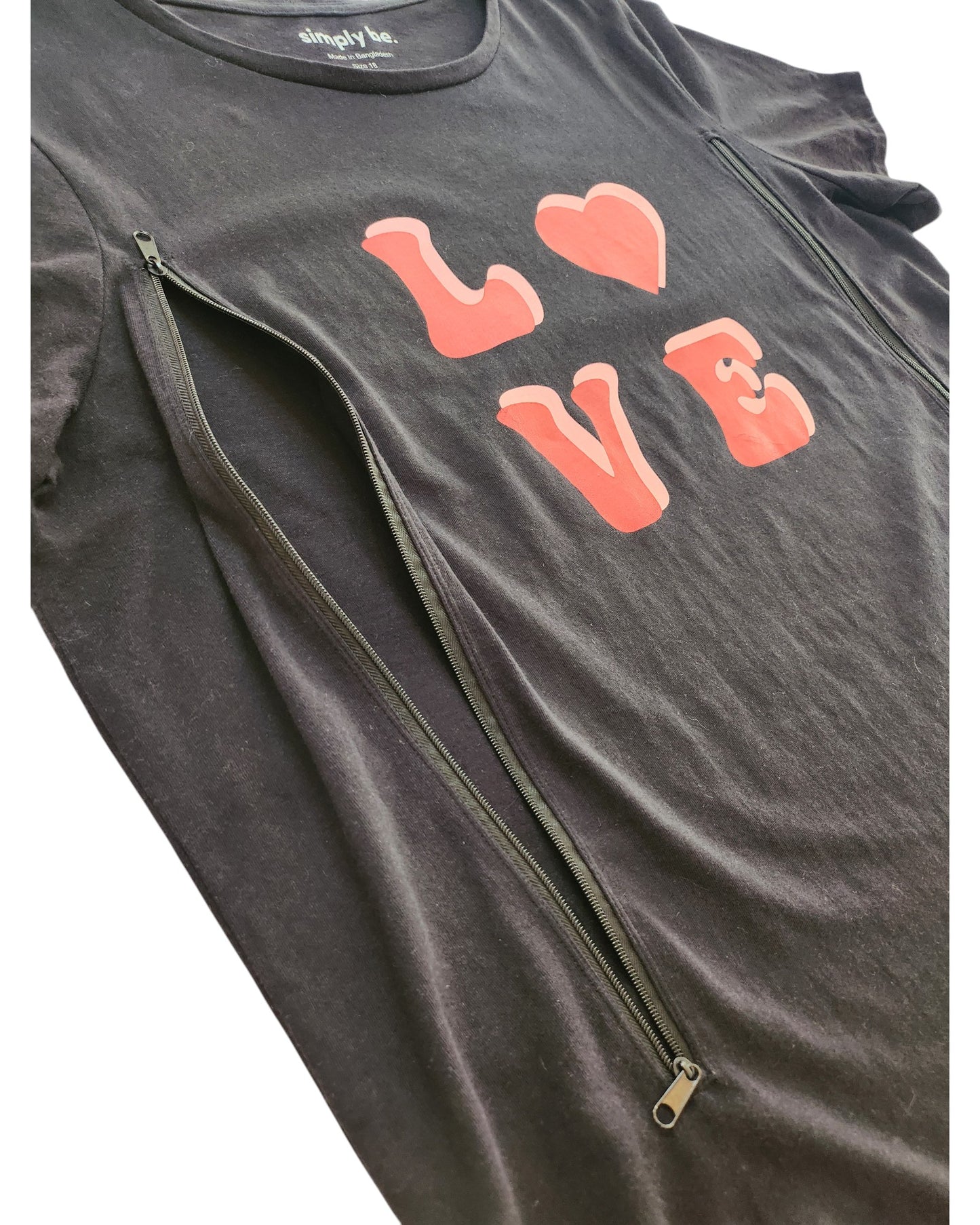 The Simply Be Upcycled Breastfeeding & Pumping Black Love t-shirt UK18 features LOVE and a red heart graphic, plus two vertical zippers for easy nursing—combining modern style and practical access for mums.