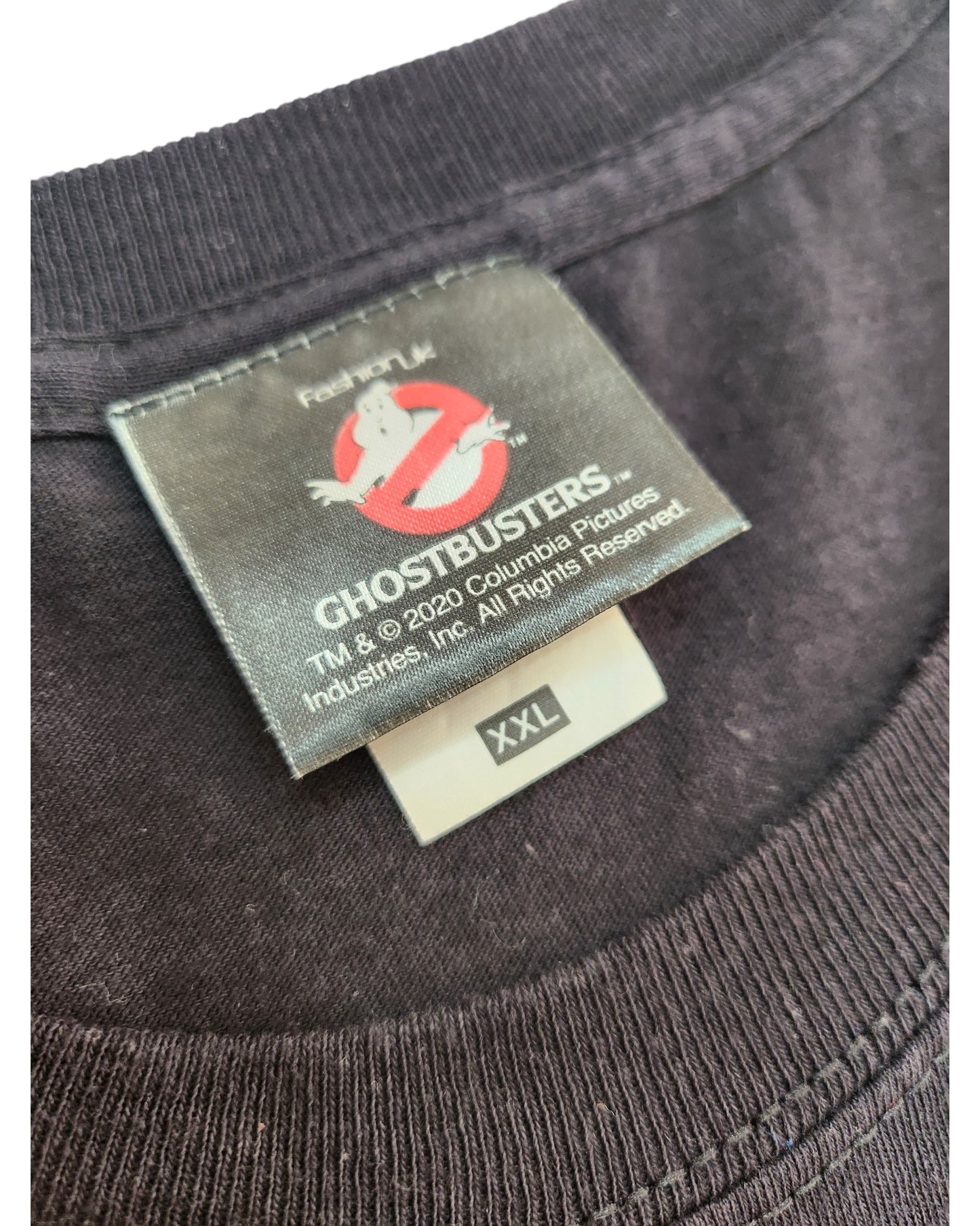 Close-up of a black Ghostbusters Upcycled Breastfeeding & Pumping T-shirt collar with logo tag and XXL size—ideal for fans seeking unique, nostalgic nursing style.