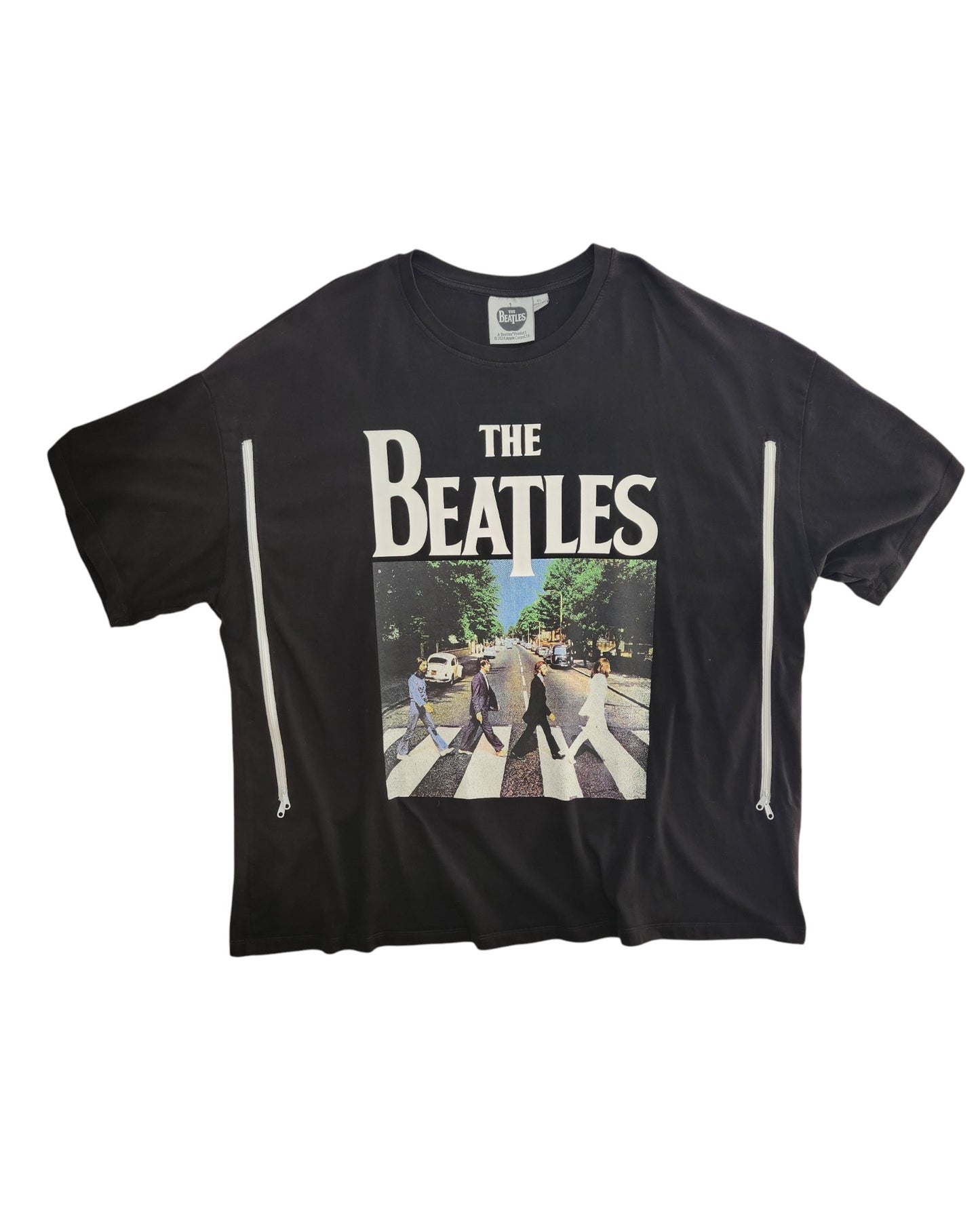 An XL upcycled black The Beatles t-shirt, designed for breastfeeding and pumping, features bold white band lettering above the Abbey Road album cover—blending sustainable style with nursing convenience.