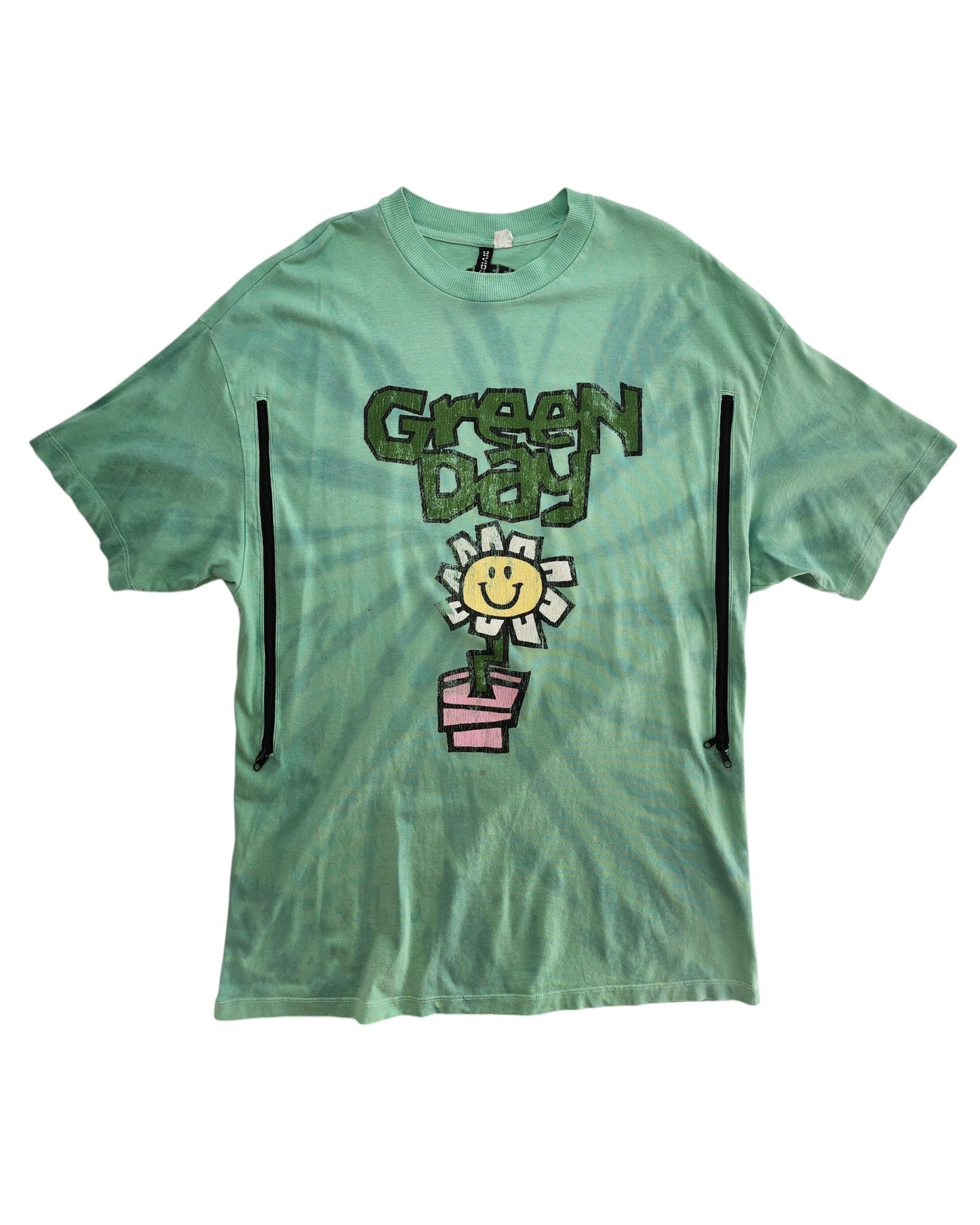 Upcycled XS H&M Green Day Band nursing t-shirt with a green tie-dye design, smiling white flower in a pink pot, cartoon Green Day lettering, and two front zippers for breastfeeding or stylish preloved wear.