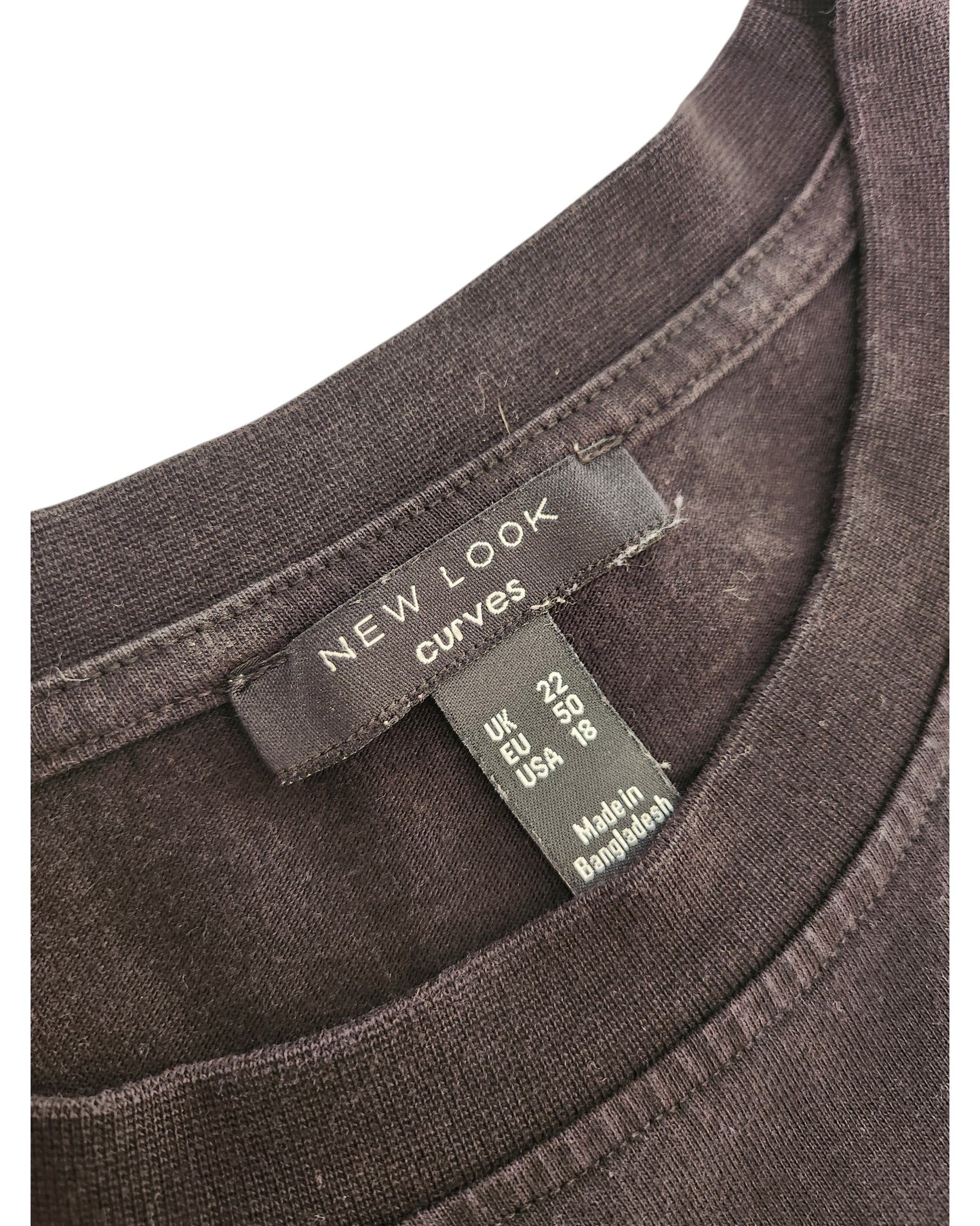 Close-up of the neckline on a New Look Upcycled Breastfeeding & Pumping Plain Black Maxi T-shirt Dress, UK22/EU50/USA18. Features labels with size details and Made in Bangladesh. A stylish addition to any preloved wardrobe.